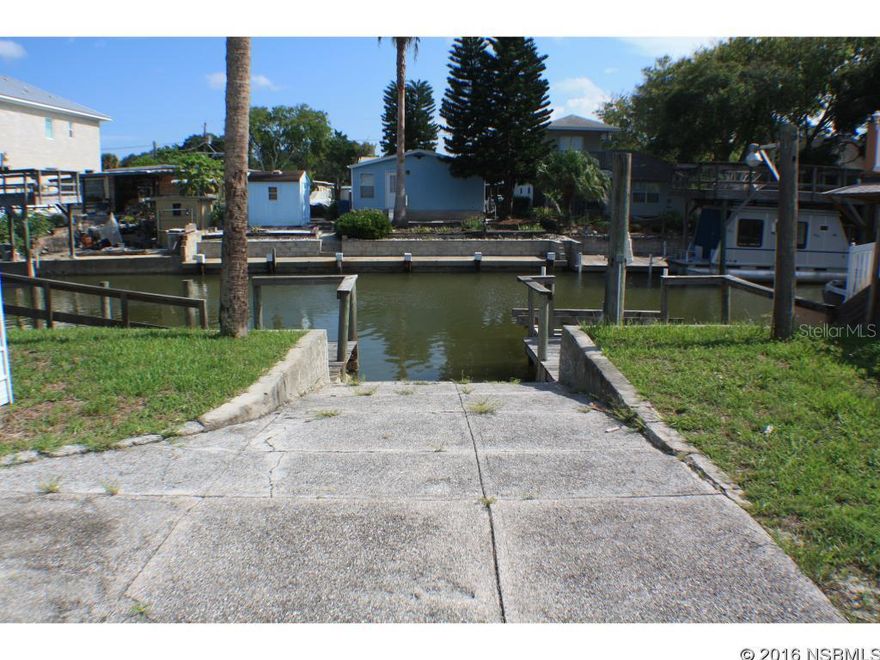 Under contract taking backups. Fisherman's Paradise! Newer Canal Front Home only 6 lots from the river, a very desirable location. Quick boating access to the Intracoastal Waterway with the best fishing in Volusia County. Newer 2005 home offers 3 bedrooms, 2 bathrooms, open floor plan and inside laundry room. Enjoy the outdoors from the screen porch or wrap around deck overlooking the water. The warfront includes seawall, boat ramp, docks, and boatlift. There is also a detached 20x14 garage for additional storage. No HOA, City water, City sewer, Paved Street. ;Water: City