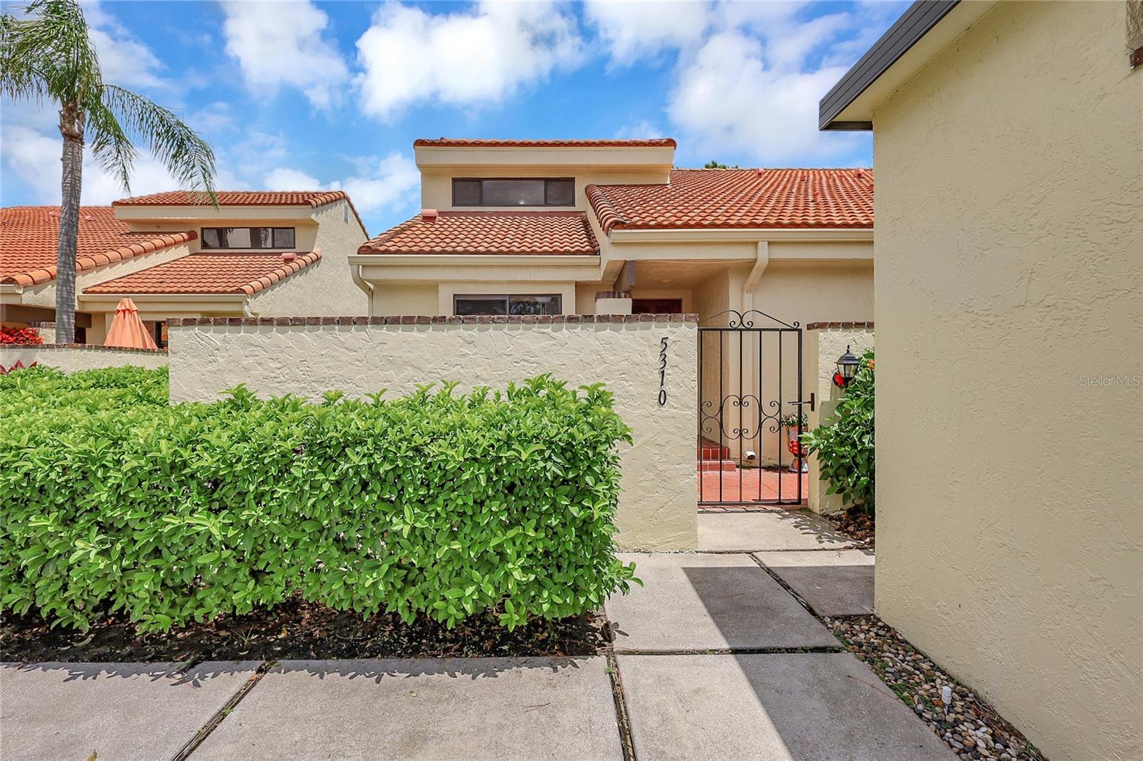 SIGNIFICANT PRICE REDUCTION IN THE MEADOWS! This is your opportunity to own a beautifully updated 3-bedroom, 2-bath villa-style condo nestled in the heart of Huntingwood, a picturesque enclave within The Meadows—one of Sarasota’s most beloved communities. From the moment you enter through the charming wrought iron gate, you're greeted by a private front courtyard patio—an ideal setting for morning coffee or al fresco evenings. Step inside to discover a bright and airy open-concept living space with soaring vaulted ceilings and wall-to-wall windows that fill the home with natural light and warmth. The spacious first-floor primary suite is a private retreat featuring generous closet space, dual vanities, and a walk-in shower—the kind of suite that feels more like a luxury resort than a typical condo. Glass sliders from both the living room and master bedroom lead to an expansive screened rear lanai, where lush, tropical landscaping creates a peaceful, green backdrop. Just steps away, unwind at the community’s heated pool—like having your own spa right next door. Upstairs, you’ll find two additional bedrooms, perfect for guest accommodations, a home office, or your own creative space. A second full bathroom even includes a walk-in storage room, providing excellent extra space rarely found in similar properties. Recent upgrades include a newer AC system, hot water heater, updated appliances, electrical enhancements, and modern ceiling fans—allowing you to move in with confidence and ease. Living in The Meadows means more than just a beautiful home—it’s a lifestyle. Whether you're looking for a serene year-round residence or a spacious seasonal getaway, this gem in The Meadows checks all the boxes. Schedule your showing today—this is the one you’ve been waiting for!