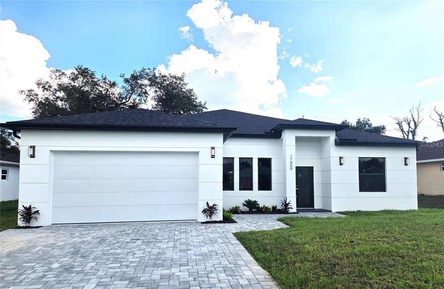 This brand-new 2025 construction offers a thoughtfully designed layout ideal for modern Florida living, with the added flexibility of a private in-law suite/apartment featuring its own entrance, bedroom, bathroom, and kitchenette and space for stackable laundry. The home provides 4 bedrooms and 3 bathrooms total across more than 2,100 square feet of living space, highlighted by an open floor plan, high ceilings, and sunlit interiors.

The kitchen is designed for both function and style, showcasing quartz countertops, custom cabinetry, stainless steel appliances, and generous prep space that flows naturally into the living and dining areas. Luxury vinyl flooring runs throughout, creating a seamless and low-maintenance finish. Impact-resistant windows enhance energy efficiency while filling the home with natural light.

Bathrooms feature clean, modern finishes, and the primary suite includes a walk-in closet and private bath. Outside, the freshly finished exterior, architectural lines, and attached two-car garage complete the home. Located on a main avenue with public water and convenient access to shopping, dining, hospitals, and area beaches, this move-in-ready property includes a builder warranty for added peace of mind.

Same floor plan and others available from this builder in other North Port locations.
