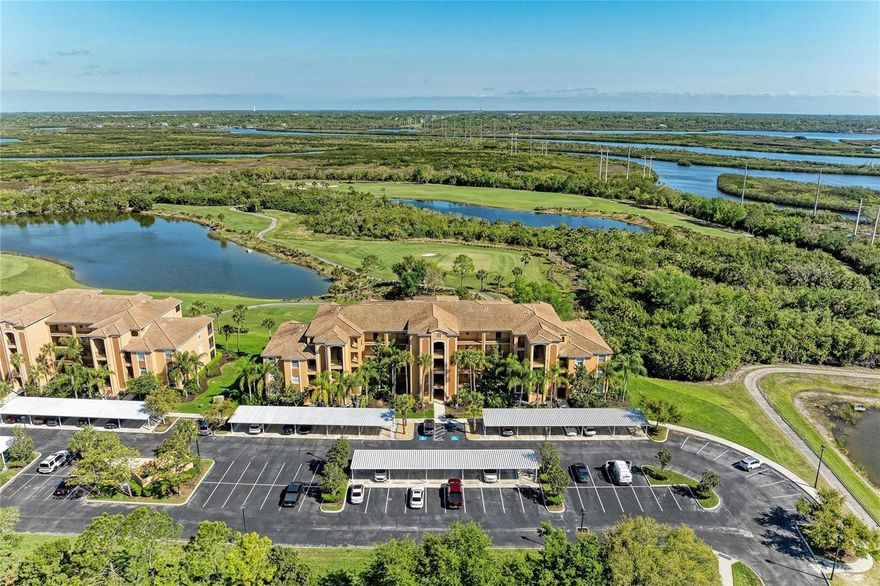 Experience high-end luxury in this truly ONE-OF-A-KIND condominium at River Strand Golf & Country Club!  With over $150,000 IN UPGRADES, this GOLF DEEDED residence is a standout showpiece filled with custom details throughout!

A welcoming entryway features a striking built-in custom mirror, offering an elegant first impression. Inside, the main living space showcases gorgeous travertine flooring throughout, an artistic feature wall  and an electric fireplace that adds warmth and style. The dining area is enhanced by an  enclosed custom shelving unit, that extends floor to ceiling and wall to wall, blending beauty with everyday functionality.

Designed for modern living, the light and bright OPEN CONCEPT LAYOUT  flows into the kitchen, which boasts a custom backsplash,  counter height matte dekton kitchen island  which was expanded and redesigned and sleek European-style white lacquer cabinetry. Newer Frigidaire appliances (2024),  and  an added custom pantry  provide exceptional storage and design.  Sliding glass doors open to a private screened lanai, showcasing LONG PICTURESQUE WATER VIEWS and stunning tee-to-green golf course vistas.  

Stylish wall accents, contemporary lighting, custom fans and refined window treatments and blinds contribute to the home’s sophisticated ambiance. The main living area was painted (2025), laminate flooring and custom closets installed in both bedrooms (2026) and LG front loading washer and dryer were installed in 2024.  The primary suite offers a serene retreat, complete with a redesigned en-suite bath featuring an elegant shower,  modern mirror  and smart floating vanity. The guest bedroom is equally impressive, paired with an updated bathroom to match the en suite that includes a custom mirror, vanity, and beautifully finished shower. Also including a storage room and assigned covered carport, this home truly is truly complete in every way and perfectly combines convenience and luxury. River Strand is a gated, resort-style community renowned for its 27 holes of pristine golf. The recently completed $9 million CLUBHOUSE RENOVATION has elevated the lifestyle experience, featuring a beautifully updated grille room and RESTAURANT, inviting outdoor dining area, and a new and expanded tiki bar with dining space.

Residents enjoy an impressive array of amenities, including two main community pools and spas, six satellite pools, two fitness centers, and both tennis and pickleball courts. A full calendar of social events and fitness activities adds to the vibrant community atmosphere.

Ideally located just minutes from I-75 and the new Marketplace with an expanding selection of dining and shopping options, and  convenient access to the stunning Gulf Coast beaches too!  Come and see this gorgeous home and this exceptional community, once you experience River Strand at it's best, you may never want to leave!