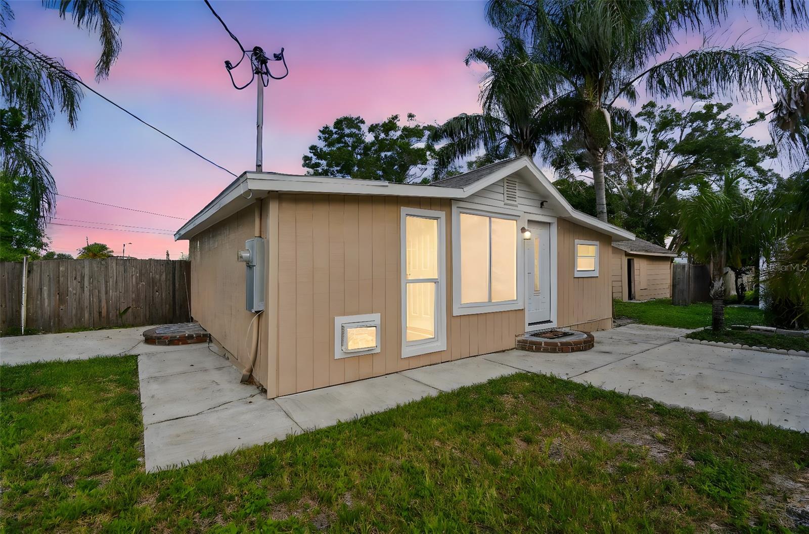 Rare investment opportunity in unincorporated Clearwater, FL just minutes from the beach—offering endless potential as a business property, rental, or primary residence. Zoned C-2 (ROR) and situated on a quiet dead-end street, this versatile property features three separate structures: a charming 2-bedroom, 1-bath Florida bungalow, a 14x29 detached garage with washer and dryer hookups, and a 15x30 workshop/storage building with power, A/C, built-in shelving, and a concrete slab—perfect for tools, equipment, or inventory. Whether you're looking to run a salon, barbershop, esthetician studio, office, or short-term rentals or Airbnb (all uses to be verified with Pinellas County Zoning), this is a rare opportunity to live and work from the same location. Mature tropical landscaping surrounds the home and outbuildings, and there’s ample room to park any vehicles securely behind the six-foot privacy fence. An outdoor shower and spacious yard add even more convenience and charm. Located just 2 miles from downtown Clearwater, 1 mile from Morton Plant Hospital, and 2.5 miles from Clearwater Beach, this property is surrounded by shopping, restaurants, parks, and entertainment with easy access to Largo, Dunedin, and St. Petersburg. If you’ve been looking to invest in yourself and take your career to the next level while enjoying the freedom of living where you work, this might be the perfect fit.
