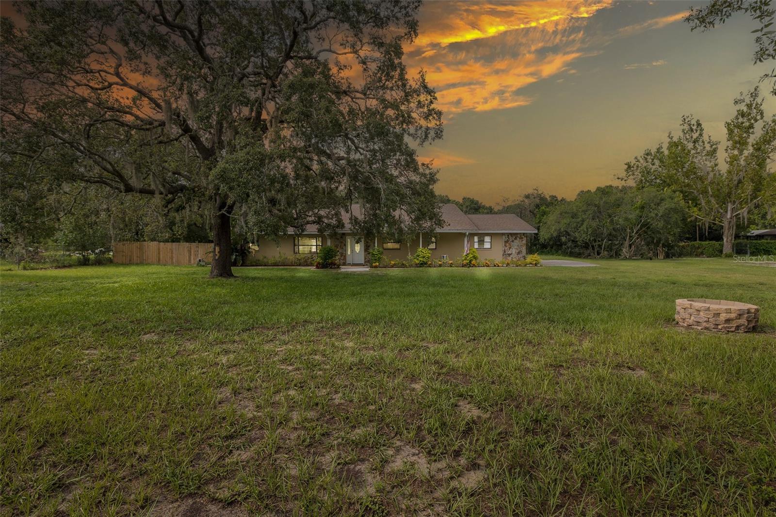 Valuable Beautiful 2.41 acres with a 4 Bedroom 3 1/2 bathroom 3 Car Detached Garage home in a very Central Location. Convenient for shopping, entertainment and dining. Hwy 52 is located around the corner with easy access to Suncoast Parkway,Tampa, or Hwy 75. This home has been renovated. New Front Door, Stainless Steel Appliances,Electrical Panel,Water Heater,Roof,Air Condition, New Pool Screening,Fresh Paint,Carpet,Kitchen and Bathroom Cabinets, Granite Countertops, New Roof and Siding on the 6 Stall Barn. New Vinyl in place for the in ground pool and Pool Cage has new screening and Cables.The property is fenced. Brick Fireplace with a huge Great Room. Designed for entertainment with open concept flow to the kitchen and dining room. In-Law Suite with separate entrance. Suite has a bedroom, living room, kitchenette, bathroom.Backyard Paradise with plenty of room to roam.Garden Beds and 6 stall barn.Mature Live Oak trees and Fruit trees. Deep Well approximately 165 ft. with 2 Septic Tanks and new drain fields. Designed for entertainment with an open concept flow to the kitchen and dining area. This is a very family friendly safe place to live. Move in Ready.