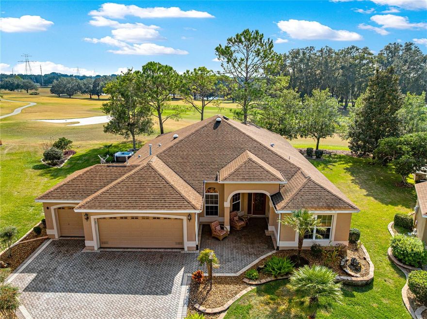 Fall in love the moment you arrive.
Perfectly positioned on Hole 8 of the beautiful Nancy Lopez Championship Golf Course, this gorgeous, impeccably staged EXPANDED magnolia (GARDENIA) model offers sweeping panoramic views and a feeling of calm, comfort, and effortless Florida living.
From the brick-paver walkway to the light-filled interior, this home is pristine, welcoming, and truly move-in ready. The open, split floor plan flows beautifully, with engineered wood floors, plush carpeting where comfort matters most, and elegant crown molding throughout. Every space feels thoughtfully designed, warm, and inviting.
The kitchen is the heart of the home—bright, functional, and perfect for gathering—featuring granite countertops, stainless steel appliances, double ovens, pull-out shelving, and a solar tube that fills the space with natural light. Both bathrooms echo the same timeless finishes.
At the end of the day, retreat to the peaceful primary suite, complete with two oversized walk-in closets, additional storage, dual sinks and a walk-in shower—your own private escape.
The true magic happens out back. The OVERSIZED Florida room, with engineered wood flooring and stunning PANORAMIC golf course views, opens to an oversized screened lanai, then continues onto a brick-paver patio with working hot tub. Whether you’re enjoying quiet mornings, sunset evenings, watching a rocket launch or entertaining friends, this outdoor space is simply unforgettable. There is even room to add a POOL if you wish.
Additional highlights include:
• New A/C (August 2025)
• Brand-new roof to be installed prior to closing
• Oversized two-car garage plus golf cart garage
• Immaculate painted garage floors
• Spacious laundry room with sink, storage, and natural light
• Special dog-friendly potty area (ask for details)

With over 1,000 square feet of brick pavers, breathtaking views, and a home that shows like a model, this is more than a house—it’s a place to truly live, relax, and enjoy every day.
Homes this clean, this beautiful, this well-located and priced like this - don’t last .
Located in the rarely available Village of Briar Meadow, this home is less than 1 mile from Nancy Lopez Country Club & Restaurant, Pool, and just minutes from the First Responders Recreation Center, VA clinic, Sumter Landing and Spanish Springs town square with shopping, dining, and free nightly entertainment! Don't miss your chance to claim this little slice of paradise! This 55+ Community (the world's largest retirement community)awaits you with unparalleled amenities, over 100 restaurants, Music every night, 90 miles of golfcart paths, in 3 counties...more holes of golf than ANYWHERE! What are you waiting for!!
Please note staged items DO NOT CONVEY.