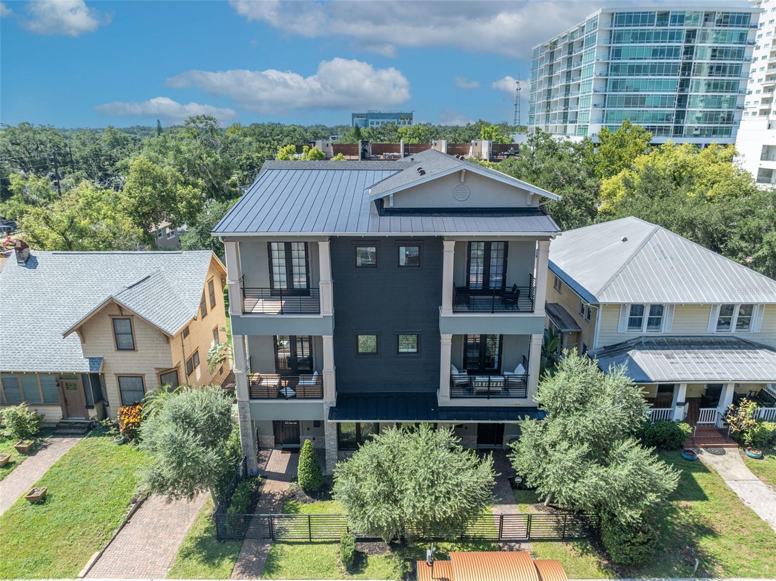Step into luxury in the heart of Downtown Orlando with this stunning townhome, perfectly located near Thornton Park. Designed with elegance and function in mind, this residence showcases top of the line Viking appliances, wine storage, and a gas range, perfect for a home chef and entertaining. Soaring 10-foot ceilings and two private balconies create an airy, inviting atmosphere, while every bedroom features a custom built-in closet system for smart, streamlined storage. A spacious, 2-car garage features tall ceilings, professional-grade overhead storage, and a versatile wall-mounted system to keep everything in its place. Located just minutes away from Thornton Park, the Dr. Phillips Center, Kia Center, Exploria Stadium, and some of Orlando’s finest dining and shopping. With quick access to the airport, major highways, and theme parks, this home offers the perfect mix of luxury city life in a perfect location. Don’t miss the chance to make this elevated retreat your own. Schedule a private showing today.
