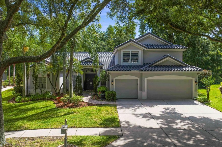 Located within the gated village of The Alcove in Arbor Greene, this beautifully updated pool home combines timeless design, functional living space, and one of New Tampa’s most sought-after resort-style communities.

Situated on a private fenced conservation homesite, this 4-bedroom, 3-bath home with a dedicated office/den, oversized bonus room, and 3-car garage offers over 3,000 square feet of thoughtfully designed living space with an open and highly livable floor plan.
The main living areas have been extensively updated with rich dark engineered hardwood flooring, creating a warm and sophisticated feel throughout the home. Neutral designer paint colors complement the natural light and volume ceilings, giving the entire property a fresh, modern look while maintaining the comfort and functionality Arbor Greene buyers are looking for.

The kitchen opens seamlessly to the spacious family room and features solid wood cabinetry, a breakfast bar, built-in desk area, closet pantry, separate dinette space, and direct views of the pool and conservation beyond. Formal living and dining spaces provide flexibility for entertaining, while the private office/den offers an ideal work-from-home setup.

The first-floor primary suite overlooks the peaceful backyard and includes dual vanities, a garden tub, separate walk-in shower, and generous closet space. Upstairs, the large bonus room creates the perfect secondary living area, media room, game room, or teen retreat with additional storage space rarely found in homes of this era.

Outdoor living is equally impressive with a screened pool, newly sealed pavers surrounding the pool deck, covered lanai space, and a fenced yard ideal for pets, entertaining, or simply enjoying the privacy of the conservation setting. A brand-new tile roof adds significant long-term value and peace of mind.

Arbor Greene is one of New Tampa’s premier master-planned gated communities, spanning nearly 600 acres of mature landscaping, lakes, nature preserves, and walking trails. Residents enjoy 24-hour manned security along with resort-style amenities including two community pools, a junior Olympic lap pool, fitness center, tennis courts, pickleball courts, playgrounds, parks, and a beautifully renovated clubhouse with year-round community events and activities.

Located just minutes from top-rated schools, shopping, dining, hospitals, golf, Flatwoods Park, I-75, and downtown Tampa access, this home offers the combination of location, privacy, updates, and community lifestyle that is increasingly difficult to find in New Tampa.