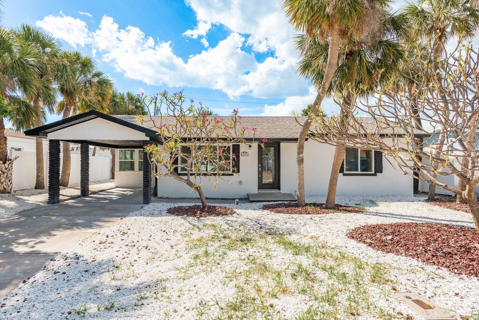 One or more photo(s) has been virtually staged. Welcome to this fully renovated 2-bedroom, 1-bathroom POOL home in the heart of St. Pete Beach. This home has a NEW 2025 A/C unit with warranty, NEW 2025 water heater, brand new ductwork, NEW PVC plumbing above grade, a brand new electrical panel, full house re-wiring, NEW 2025 luxury vinyl plank flooring, NEW hurricane-rated windows, updated outlets, fresh interior and exterior paint, and more! Step inside to the brand new, gorgeous open kitchen with soft-close cabinets, quartz countertops, a designer backsplash, and brand new stainless steel appliances. The living and dining room combo creates a bright, inviting space ideal for relaxing or entertaining. The fully renovated bathroom showcases a sleek new vanity, modern lighting, and a tiled shower with glass enclosure. Enjoy your private backyard oasis featuring a screened-in, salt water pool with pavered deck and enclosure, a covered area for outdoor dining, and a vinyl-fenced yard with easy-to-maintain tropical landscaping — perfect for grilling, lounging, or soaking up the sun. All of this with NO HOA and just minutes to Caddy’s Treasure Island, Sea Dog Brewery, the St. Pete Beach Dog Park, endless dining, shopping, and, of course, world-famous beaches and water activities! Don’t miss your chance to own a beautifully updated beach retreat - where every day feels like a vacation.