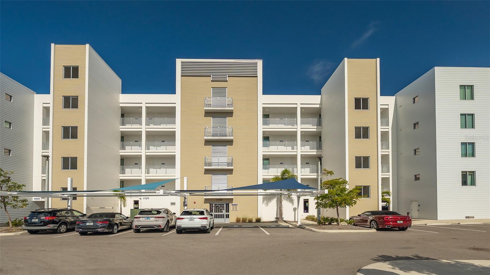 Location, location, location with water views. The Strand of Sarasota on Whitacre Bayou built in 2022 has two buildings with 147 units. Our building 1709 has 108 units in it, four floors, with 27 units per floor, and faces the water and all units have direct bayou water views. This complex has its own marina with 42 slips. This unit does NOT have a boat slip. There is a community clubhouse (1705) with a fitness center, grilling area, firepit, swimming pool, dog park, kayak and canoe storage and launch to access the Bayou. There is also an on-site manager. This fourth floor unit is a one-bedroom, with one and one-half bathrooms with 896 square feet of living space and the largest open, but covered 119 square foot balcony. One can see the Bay from the balcony and all the living area has a bayou water view. This unit is being sold turnkey-furnished, and has quartz countertops and tile flooring throughout. The primary bedroom is carpet and faces the front of the building. The primary bathroom has a single-sink and only the upgraded, larger shower stall. This unit has a deeded and assigned under building parking space #4 (10 x 17) and a deeded under building 3 x 6 storage cage, just to the left of the parking space. There is more than enough guest and second-car parking all over the complex. Unit A408 is the second unit from the left on that floor of the eight other units (401 to 409). This complex rental restrictions are a seven-day minimum 52 weeks a year, if desired. Two pets, dog or cat are allowed with no weight limit. The monthly maintenance fees are less than $500 and this seller has paid the first half of the only assessment due, with the balance of $1,780 due 08/01 for the 2025 calendar year. This unit's monthly utility costs average $65 for water, sewer, trash and recycle and $50 for electricity. All the appliances and the HVAC system are only two years new. This is a must-see for a individual, or couple who want to be on the water close to Downtown Sarasota.