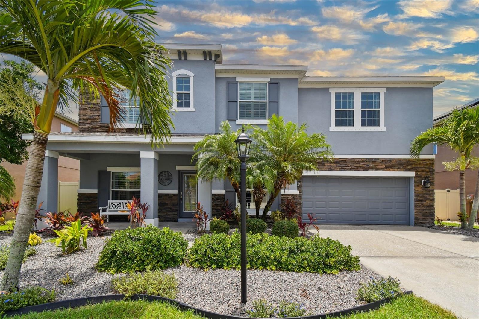 Impeccable design. Exceptional value. Prime location. Welcome to Bayou Cove—an exclusive enclave of just 22 homes, ideally across from the prestigious Bayou Club. Built in 2012 and in a non-flood zone, this impeccably maintained five-bedroom, three-and-a-half-bath pool home blends timeless craftsmanship with thoughtful updates throughout. Go inside to a spacious open-concept layout designed for effortless everyday living and elegant entertaining. The chef’s kitchen is a standout, featuring granite countertops, 42-inch wood cabinetry, Energy Star appliances, a walk-in pantry, and an oversized breakfast bar that seamlessly connects to the family room with its striking tray ceiling. The first floor also includes a dedicated office/den, formal dining room, and a serene primary suite—all with rich hardwood floors. The en-suite bath offers dual vanities with granite countertops, a soaking tub, separate shower and a generous walk-in closet, which has been thoughtfully redesigned by Closets by Design to maximize space and style. Upstairs, a sprawling bonus room anchors four additional bedrooms and two full baths—one of which is a dual-access bath connecting two of the bedrooms—ideal for guests or growing families. All bedrooms are outfitted with energy-efficient double-pane windows and custom interior shutters for privacy and style. In addition to over $130,000 in original builder upgrades, the home features a long list of recent improvements. The kitchen cabinets have been professionally resurfaced and repainted for a crisp, modern finish. A new HVAC system, water heater, and water softener were installed in 2025. The garage has been upgraded with epoxy flooring, ceiling-mounted storage and a new garage door opener. Outside, the home features new pool pavers, a new pool pump (2024), new fencing, and privacy palms to enhance aesthetics and seclusion. Solar panels offer long-term energy efficiency, and the exterior was freshly painted in 2024 for an updated, polished look. Go outside to your private retreat, a screened saltwater pool surrounded by lush greenery and generous patio space to relax or entertain. Hurricane shutters are included for added peace of mind. Built with solid block construction on both stories for exceptional strength, energy efficiency and peace of mind, this Bayou Cove home offers the rare combination of modern construction, prime location and enduring design. Don’t miss your chance to own one of its finest residences.