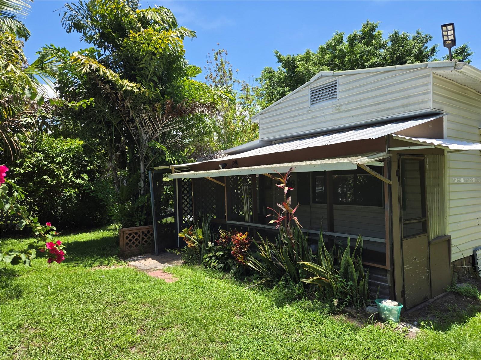 Move-in ready and priced to sell! This charming and freshly painted 2 bedroom, 1.5 bath home offers spacious living with an open-concept layout. Enjoy waterfront views from the primary bedroom, which features sliding glass doors leading to a private, screened wooden patio.
The second bedroom also opens to a large screened patio, perfect for relaxing or entertaining. The Florida room with French doors leads to a cozy screened patio, adding even more living space.
Located on a fully fenced 1/4-acre lot, this SWMH with addition offers privacy, four screened patios, and four storage sheds. The gated driveway provides added security and convenience. Call to schedule your walk through today, it won't last long at this price!
CASH ONLY DUE TO AGE OF HOME.