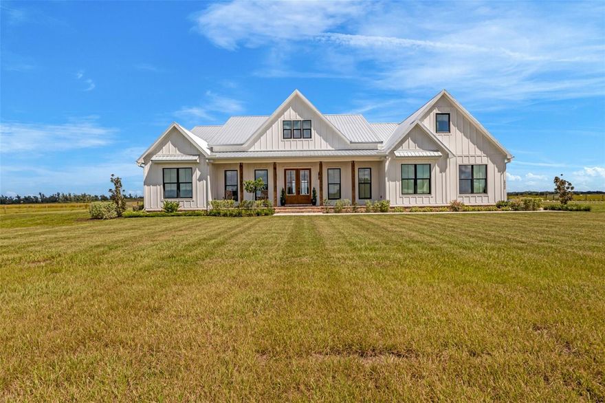 Welcome to your dream retreat in the heart of DeSoto County. Set on 10.25± acres with a private pond, this 2023-built custom farmhouse blends timeless charm with modern luxury. From the moment you arrive, the board-and-batten hardboard siding, brick accents, and durable metal roof set the tone for the quality and craftsmanship throughout.

Step inside and you’re greeted by soaring vaulted ceilings, wide-plank LVP wood look floors, and walls of windows that frame sweeping views of the surrounding pasture. The open-concept living area features a gorgeous brick fireplace with custom built-ins, creating the perfect place to gather with family and friends.

The kitchen is the true centerpiece of this home, designed for both everyday living and entertaining. Brick accents, a large center island, and double ovens provide warmth and function, while an oversized refrigerator and walk-in butler’s pantry make storage effortless. Just off the kitchen, the spacious dining area flows seamlessly to the expansive back porch where herringbone brick floors, tongue-and-groove ceilings, and pastoral views set the stage for unforgettable evenings outdoors.

The primary suite is a private sanctuary with a spa-inspired bathroom offering dual vanities, a soaking tub, and a walk-in shower. A custom-designed closet provides abundant storage with built-in shelving and drawers. Two additional bedrooms, a dedicated office, and a generous laundry room with farmhouse sink add to the home’s thoughtful design.

Beyond the home, the land is ready for your vision Whether it’s horses, cattle, gardening, or simply enjoying wide open space. The property is fully fenced and designed for those who value both privacy and the freedom of country living, yet it remains just minutes from the conveniences of Arcadia.

This is more than a home, it’s a lifestyle. A place where modern amenities meet timeless farmhouse style, and where every sunrise over the pasture reminds you that you’re exactly where you’re meant to be.