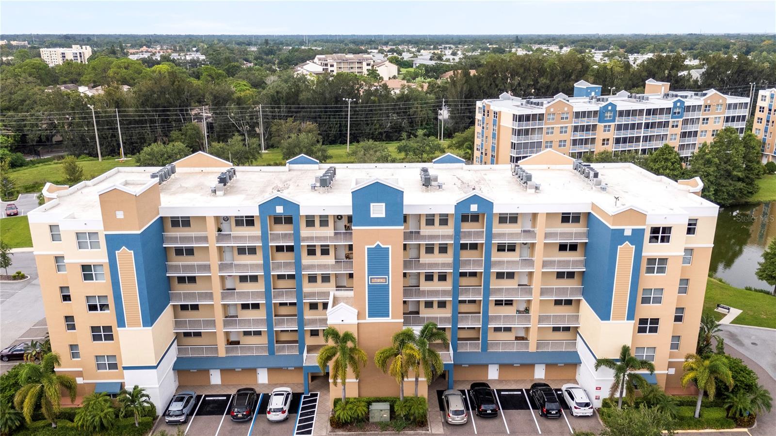 One or more photo(s) has been virtually staged. Welcome to this beautifully maintained 2-bedroom, 2-bath turn-key condo in the desirable Golf Lake Condos community which offers comfort, convenience, and peace of mind. The unit features a private balcony, a modern kitchen with appliances just 1.5 years old, and a newer A/C unit only one year old. The spacious primary bedroom features a large en suite with two walk-in closets for his and hers. No need for a laundry facility. This unit offers your very own laundry closet with a washer and dryer for convenience. A designated parking space is located directly in front of the building, with guest and second-vehicle parking nearby. Everyday living is made easy with a trash chute just steps away, along with close access to the elevator and mailboxes. Building 5, known for its all-concrete construction, exceptional design, management, and maintenance, features concrete block exterior walls and walls between condos ensuring durability, safety, and energy efficiency minimizing heating and cooling costs. Residents benefit from a completed Structural Integrity Reserve Study with minor issues already addressed, and no milestone inspection required until 2037. Building 5 is also elevated, high and dry, with NO EVACUATION NECESSARY. The south front exposure shields the living room and primary bedroom from the hot direct afternoon sun reducing A/C costs and allowing year-round enjoyment of your screened in lanai. The community offers two sparkling in-ground spas and a resort-style clubhouse, while relatively low HOA fees cover insurance, grounds and building maintenance, pool, clubhouse, water, sewer, trash, cable, high-speed internet, and fully funded reserves. Surrounded by abundant wildlife and natural beauty, Golf Lake provides a tranquil retreat with easy access to beaches, shopping, dining, entertainment, and Florida’s top attractions. Schedule your showing today!