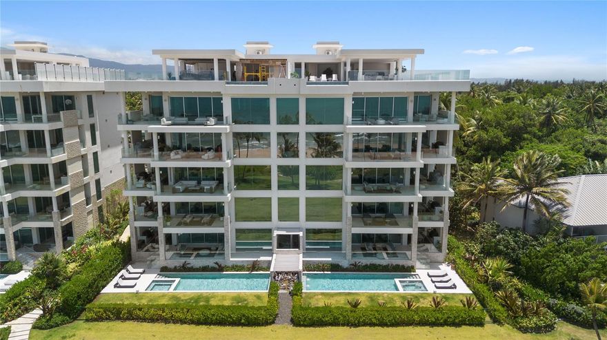 Immerse yourself in refined coastal living at this impeccably designed Garden Residence on Ocean Drive, located within the world-renowned St. Regis Bahia Beach Resort.
This exceptional first-floor beachfront corner unit offers an expansive 6,190 square feet of elegantly crafted indoor and outdoor living space. Fully furnished and move-in ready, the residence features four spacious bedrooms and four-and-a-half luxurious bathrooms.
Designed with seamless indoor-outdoor flow, the home boasts a private pool, private backyard, and direct walkout access to the pristine beach. Floor-to-ceiling windows and modern architectural elements create a harmonious connection with the surrounding natural beauty, delivering an atmosphere of tranquility and sophistication.
Whether you're entertaining guests or seeking peaceful solitude, this rare coastal gem is your gateway to the ultimate resort lifestyle.
Caribbean elegance. Crafted by acclaimed SB Architects and thoughtfully curated by Hirsch Bedner Associates, the home features soaring ceilings, floor-to-ceiling windows, and an expansive, light-filled layout that opens to lush outdoor spaces. The private saltwater pool, spa jacuzzi, outdoor shower, and landscaped garden create an intimate oasis just steps from the beach.  The gourmet kitchen is equipped with Wolf and Sub-Zero appliances, Italian cabinetry, and premium finishes, while the open-plan living and dining areas extend effortlessly to covered terraces and a fully appointed outdoor kitchen and dining area—ideal for entertaining. The primary suite offers dual walk-in closets and a spa-inspired bath with space to customize a private wellness retreat, including options for a sauna, steam room, or cold plunge. Three additional en-suite bedrooms, each with custom walk-in closets, for exceptional comfort and privacy for family or guests.
Additional features include a Lutron Smart Home system, integrated sound system, water softener, laundry room, linen and storage closets, and gallery-style foyer. This pet-friendly residence also includes two assigned parking spaces (one with EV charging), a 6-seater golf cart, and access to the resort’s Hotel Service Program.
Set within the lush, private sanctuary of Bahia Beach, this unique residence with upgraded finishes redefines modern tropical luxury—offering both a tranquil retreat and an exceptional investment opportunity. Owner financing available.
As part of the St. Regis Bahia Beach Resort, residents also enjoy privileged access to world-class amenities including farm to table service, access to award winning golf course, wellness and tennis center, spa services, fine dining, water sports and nature trails. For those seeking investment potential, this residence can be enrolled in the Hotel Service Program and offers owner financing option.