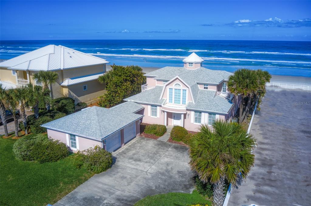 PARADISE FOUND!! BEAUTIFUL & IMMACULATE DIRECT OCEANFRONT 4BR + BONUS ROOM/4BA/2+CG FULLY FURNISHED HOME WITH NEARLY 3000 SQ. FT. OF LUXURIOUS LIVING AREA!! AWESOME OCEAN VIEWS OF THE PRISTINE ''NO-DRIVE'' SUGAR SAND BEACH IN SOUGHT AFTER PONCE INLET!! This magnificent home has a unique architecture designed to provide ample space for the comfort of family & guests while maximizing ocean views from almost every room! The newer roof, 6'' gutters and two (2) newer A/C units provide maximum energy efficiency!! The spacious and open floor plan boasts a welcoming great room, stylish beamed ceiling, electric fireplace & three sets of French doors as well as a wall of windows in the dining area for panoramic ocean views!! The chef's fully-equipped kitchen has exquisite Granite countertops, Stainless Steel appliances, a breakfast bar, center island & ample cabinet & counter space!! The main level includes two guest bedrooms plus a bonus room currently being used as a bedroom. The second level encompasses the palatial master suite with large oceanfront balcony & a luxurious master bath with jetted tub & shower with dual heads! There's also a guest bedroom on the second level. The extensive wrap around deck is perfect for relaxing and/or entertaining guests. The detached oversized two car garage has covered access to the home. Elegant coastal accents include plank flooring, bead board, crown molding & more! This home features master craftsmanship including a crowning cupola with 360 degree views!! There's an outdoor hot/cold shower for a comforting rinse after your walk on the beach!! Large inside utility/laundry room with washer & dryer included. The quaint seaside town of Ponce Inlet represents Florida coastal living at it's finest!! Soak in the beauty of the historic Ponce de Leon Lighthouse (the tallest lighthouse in Florida) or climb it after a walk on the beach for your daily workout! Walk or bike to seaside restaurants, charter fishing, Marine Science Center, gorgeous nature preserves & parks with walking trails, marinas, dog beach/park & much more!! Enjoy Florida coastal living at it's finest!! Perfect primary residence, beach home and/or investment property!! Excellent School District! Must See!!