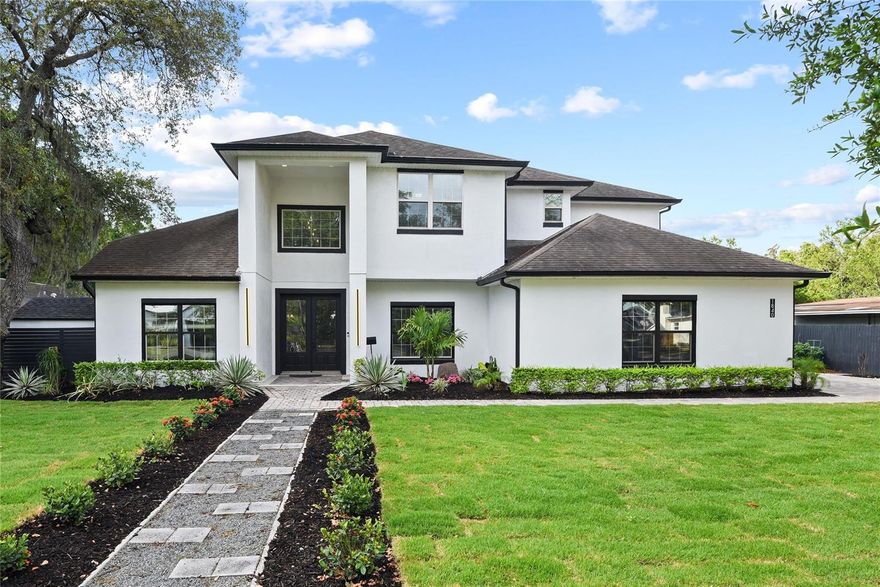 This custom 2014 built Winter Park residence is stretched over a double lot with a backyard resort style retreat yet close to all that Winter Park offers. A home with function and flexibility with a separate guest house, office or studio based on your needs. This thoughtfully designed home is sophisticated with casual comfort and showcases four bedrooms, 3.5 baths and nearly 3,800 square feet, downstairs main and additional guest suite, and upstairs includes remaining beds and baths. An inviting foyer welcomes you with volume ceilings, wood floors and a large transom window that allows beautiful natural light in. The family room is spacious with a marble wrap electric fireplace with lighting detail and niche for a flat screen TV. Clear glass doors across the back of the house lead you to the outside covered porch for ease of entertainment. The kitchen is open, light and bright with 42-inch shaker double stack cabinetry, large pantry and great workspace, a peninsula with bar seating as well as an eat-in kitchen area for large gatherings. Stainless appliances, granite counters and creative backsplash round it all out. The oversized laundry room includes an extra refrigerator and a second pantry for added convenience. The dining with tray ceiling, designer fixture and textured wallpaper add to the style of the home as well as dedicated office or flex space. Luxury continues into a primary suite with built-ins, large spa-like bath with sleek finishes, soaking tub, large dual-head shower and spacious walk-in closet. The primary suite overlooks backyard and opens to outdoor oasis with open air lanai with generous covered porch to gather or enjoy a night of alfresco dining. State-of-the-art modern resort style pool with heated spa, sun shelf with fountain feature, a fire feature runs along edge of pool and transforms the backyard into a luxurious tropical oasis particularly at night. Hardscaping elements include pathways trimmed with turf grass, professional landscape lighting that enhances and elevates the home. Don’t wait to tour this special home in the heart of Winter Park, close to the best schools with Lakemont Elementary, Glenridge Middle and Winter Park High. A mile from Park Avenue, close to hospital and walkable to the YMCA, Phelps Park and fantastic restaurants.