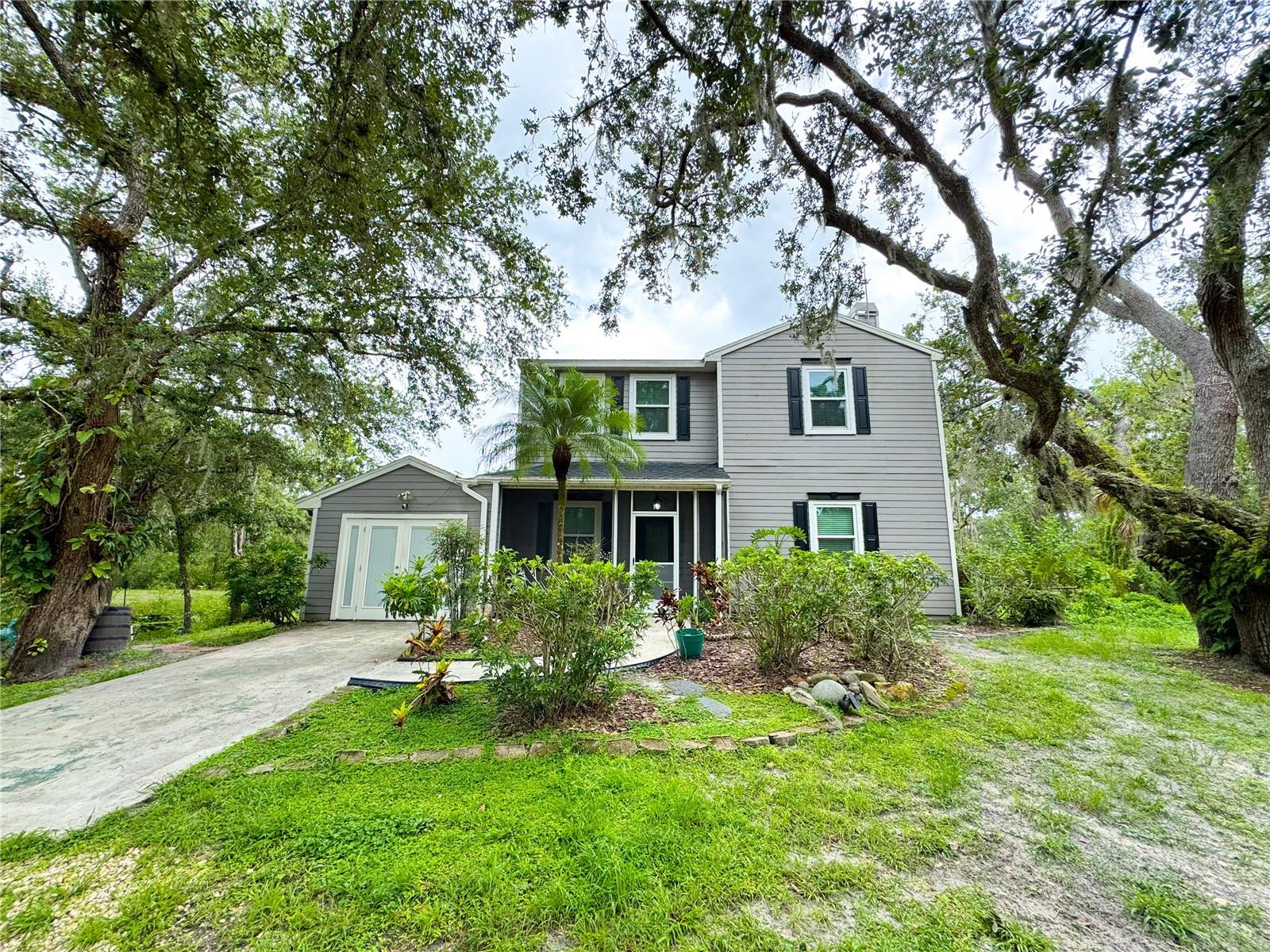 Welcome to your own private oasis. This 3 bedroom 2.5 bath home is seated on 2.23 acres of lush Florida landscape, featuring a personal creek boasting with wildlife. The home itself is renovated to the 9’s with luxury finishes throughout such as LVP flooring, quartz countertops and custom built-ins surrounding an active, stone-surfaced wood burning fireplace. The primary en-suite is very spacious with his & hers custom walk-in closet organizers and a stunning master bathroom with a sky light. This incredible home is only enhanced by the outstanding outdoor features. Some highlights include a sitting space with a fountain view, a foot bridge connecting your property across the creek, and a grand patio space to soak in all of the scenery. Additionally to the home itself, there are 3 buildings on the property, two of which are storage sheds and one is an outdoor workshop with two A/C’d rooms attached. Locationally, this house is ideally seated at only a quick 10 minute drive to Lakewood Ranch. Some important updates to highlight include 2019 new impact windows, 2020 Roof, 2022 A/Cs, 2024 Septic, 2024/25 well/pump. If you’re looking for country living meets your own Florida oasis, this home is for you.