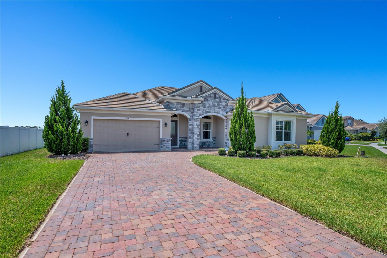 Welcome to your lakefront oasis in the heart of Winter Garden—where every day feels like a retreat.
This 4-bedroom, 3.5-bath pool home blends timeless comfort with scenic charm, offering a lifestyle defined by relaxation, functionality, and flexibility. Ideally located on a private street in a cul-de-sac, this property provides exceptional privacy and tranquility.
Step into a light-filled, open-concept floor plan where spacious living and dining areas flow seamlessly into a well-appointed kitchen with generous storage—perfectly suited for gatherings or quiet evenings at home. The serene primary suite offers a peaceful escape, complete with tranquil lake views, a private en-suite bath, and a walk-in closet. Three additional bedrooms provide versatile space to fit your lifestyle—whether for guests, hobbies, or remote work.
Outdoor living truly shines here. Enjoy morning coffee or evening sunsets from your screened lanai, where a sparkling pool and spa overlook the navigable lake and offer a front-row seat to Disney’s nightly fireworks. The expansive lanai is enhanced by a motorized screen and a fully equipped summer kitchen, perfect for effortless entertaining. The fully fenced yard provides privacy and includes expansive grounds ideal for adding a playground, sports court, or anything your family needs. Throughout the home, you’ll appreciate the beautiful, professional custom-made curtains that elevate each space.
A rare **extra-long driveway—the longest in the community—**adds exceptional parking convenience to the 3-car garage. This home is set within a vibrant community featuring a clubhouse with a resort-style pool, tennis courts, playgrounds, and scenic walking trails—all with convenient access to local shops, dining, and major highways. With every space designed to flow harmoniously toward breathtaking lake views, this home offers more than just a place to live—it’s a true sanctuary.
Don’t miss the chance to own this one-of-a-kind lakefront property. Schedule your private showing today and experience what makes this home truly exceptional.