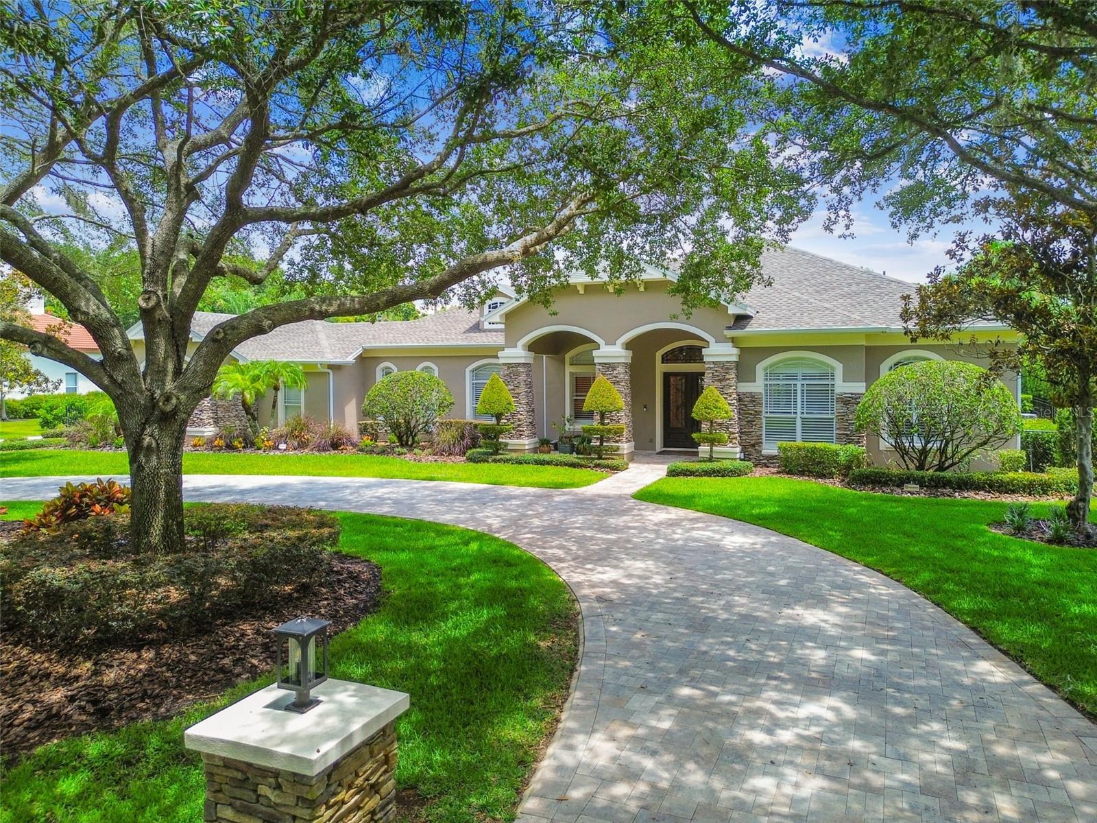 Stunning custom home located in the coveted community of Keystone Shores Estates-As you enter the Gate you are welcomed by mature, tree-lined streets and arrive at this beautiful This executive home. This truly is a rare find-excellent floor plan, plenty of rooms, fantastic location and A-RATED SCHOOLS! Meticulously maintained starting with the freshly paved circular drive with updated landscaping to luxurious lanai pool and spa area. 6 Bedrooms, 5.5 bathrooms, custom wood-unit in office, family room featuring a custom fireplace wall with a Dimplex unit plus custom-cabinetry and unique amethyst quartz countertops, Huge Game Room) plus attached 4-car garage! Almost 6000 sq ft home including an attached In-law/guest suite complete with bedroom, full bath, private kitchenette, laundry hook ups and sitting room and PRIVATE ENTRANCE at the rear of the home or from the main home.NEW ROOF 2021, INTERIOR PAINTED 2022, EXTERIOR PAINTED 2023, PLUS NEW-INSTANT HOT-WATER HEATER among a host of additional upgrades! As you enter, the large formals have custom ceilings and oversized crown Moulding. The custom kitchen hosts an open floor plan with a large Quartz Island, sub-zero refrigerator, Wolf Professional Gas Range, beautiful soft close cabinetry and more! The entertainment room is lined with windows that provide tons of natural light, HUGE STONE FIREPLACE, custom ceilings and custom woodwork along with an amazing full built-in bar complete with refrigerator, ice maker, oven, warming drawer, dishwasher and wine storage. The outdoor area has a pool with an integrated spa, bar / grill area with multiple outdoor living spaces, and a fireplace. As you open the beautifully crafted and custom-built solid wood door and enter the primary suite, you will find an oversized bedroom with custom cornices and drapery remote controlled room darkening shades, dual closets next to a resort-style bathroom with dual showers and dual-custom vanity. In addition to the dual primary closets, there is a custom-built oversized walk-in closet with luxury finishes that will excite any fashion-lover! On the other wing of the home, you will find oversized secondary bedrooms to keep siblings close, and a huge upstairs bedroom with a walk-in closet and full bath. Owners have made multiple aesthetic upgrades to this already-exquisite home that makes for an easy, turn-key transaction! Keystone Shores is a gated community that offers a large lake with a dock available for fishing, basketball & tennis courts & a playground. Easy access to The Veterans Expressway, Convenient to Tampa International Airport, downtown Tampa, shopping, restaurants and beautiful Gulf Coast Beaches