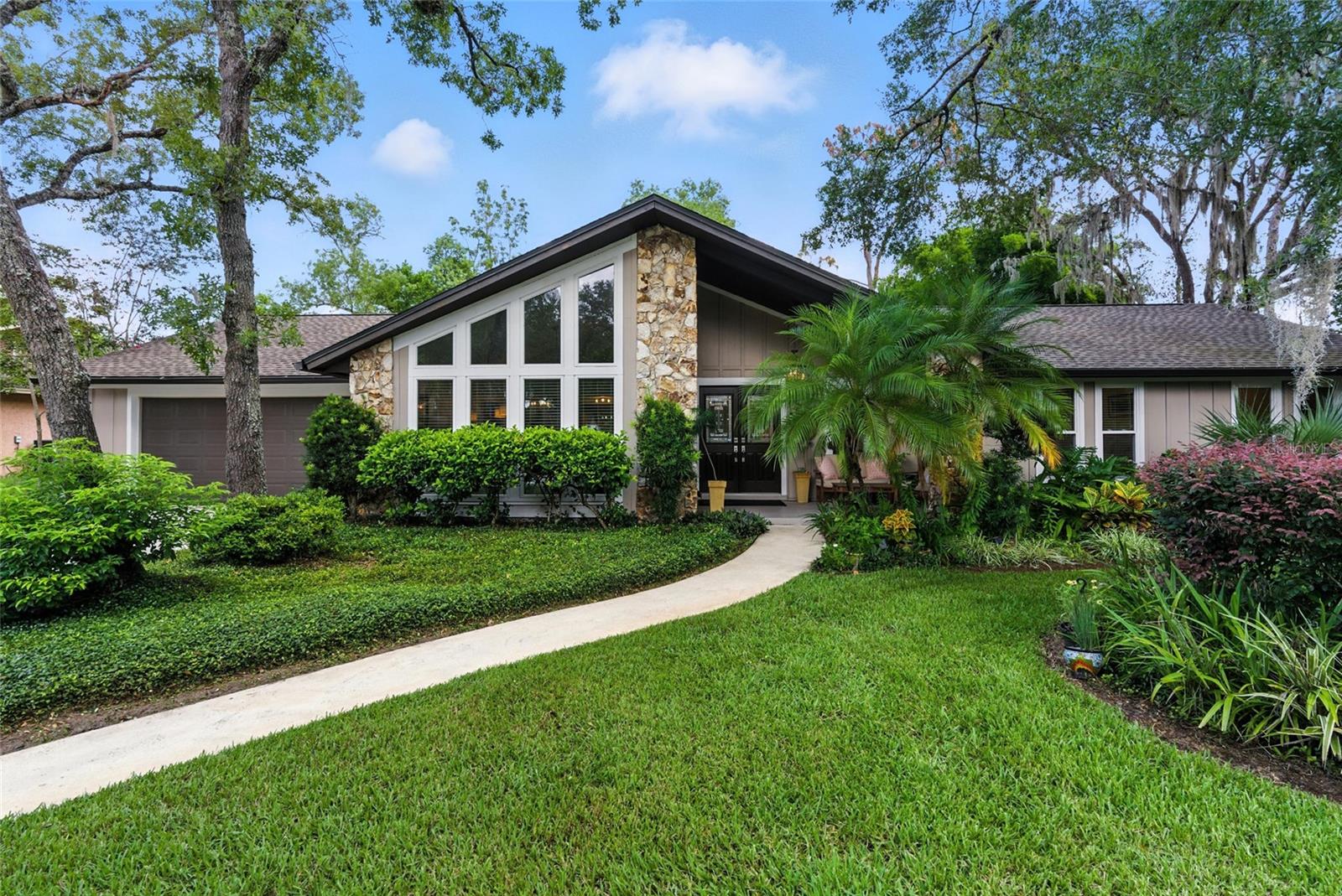 Welcome to 102 Sweetwater Hills Drive, where decades of architecture and landscape design experience come to light in both the front and backyard spaces, creating ‘outdoor rooms’ of lush, leafy luxury! Towering privacy trees skim the sky to form a natural canopy that sways gently in the breeze for serenity year-round. The carefully curated plant selections attract an abundance of birds, butterflies, and other pollinators to all outdoor spaces. Guests are welcomed through the front double doors into a high-design remodel featuring a harmonious blend of tile and luxury vinyl flooring, vaulted ceilings, and a flood of natural sunlight streaming in from two entryway skylights. To your left, a flexible living space with floor-to-ceiling windows provides a front-row seat to the vibrant display of natural life just beyond the glass. This 2018 fully upgraded kitchen brings the heat with stainless steel appliances, modern soft-close cabinetry, and an oversized island with extra storage drawers—perfectly positioned to spark conversation as it flows seamlessly into the living room. On cool evenings, slide open the 3-panel glass doors in the living area and gather around the warmth of the real wood-burning fireplace for effortless indoor-outdoor entertaining. The primary suite delivers serious wow-factor! It's spacious enough for a king-size bed and features 3-pane sliding glass doors that lead straight to your private pool escape, blurring the line between luxury and lifestyle. ADDITIONAL STANDOUT UPGRADES: Transferable warranty roof (2023), a shed (2022), Hardie fiber front soffit overhang (2021), Hardie fiber rear patio beam & posts (2021), pool heater (2021), rear patio tile (2021), guest bath renovation (2020), primary bath renovation (2020), double-pane windows throughout (2018), water heater (2017), R38 insulation (2016), and a new A/C system (2015). More than walls and rooms, this home delivers a lifestyle that raises the bar. Located in a top-tier school district, residents score exclusive access to skiable Lake Brantley and Sweetwater Beach, plus an arsenal of amenities: 8 tennis and pickleball courts, multiple basketball courts, playgrounds, covered pavilions, a sand volleyball court, fishing dock, full soccer and baseball fields, and a gated boat ramp. Enjoy a more scenic adventure with gated access to the Wekiva River—just a peaceful 10-minute paddle to Wekiva Island and Wekiwa Springs. Schedule a tour quickly before it’s off the market!