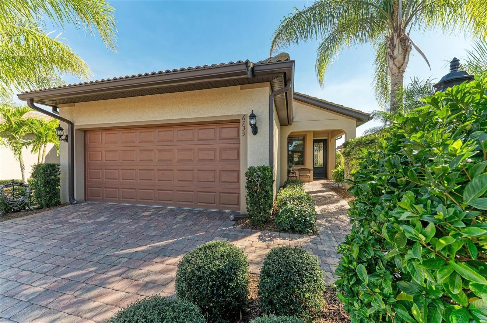 Welcome to active resort living in the fabulous Del Webb - Lakewood Ranch’s premier 55+ neighborhood. This immaculate single-family home is quality-built and will impress even the most discerning buyer. The tile roof, paver driveway, and lush landscaping with inviting curb appeal. Stepping into the home, the soft sun-kissed interior offers incredibly efficient space and charming details. A front entry leads to a separate den and the light & bright great room. The stunning kitchen features classic rich maple cabinets, sparkling stainless steel appliances including a natural gas range, a gourmet island, and gorgeous Cambria Aria quartz countertops. A lovely window overlooks the deep landscaped backyard and offers the perfect spot for birdwatching as you’re preparing meals or entertaining. The split floorplan provides ideal privacy with two bedrooms in adjacent corners. The primary suite is a relaxing haven with adjoined en-suite, walk-in shower, and spacious walk-in closet. Both bathrooms feature comfort-height vanities and toilets, the laundry room is convenient and tucked out of the way, and there is plentiful storage space. The garage includes a utility sink, and the home is equipped with a whole-home surge protector. Outside, a covered lanai offers shade to relax and enjoy the Florida weather. Del Webb is a renowned community offering residents a peaceful and healthy active lifestyle with a full-time activities director, a resort-style pool & spa, pickleball, athletic facility, walking paths, and lakeside restaurant. Prime Lakewood Ranch location for easy access to various grocers, restaurants, shops, farmers markets, medical facilities, the new library & community center, polo matches, and so much more. Schedule your private tour as this home must be seen to be appreciated!