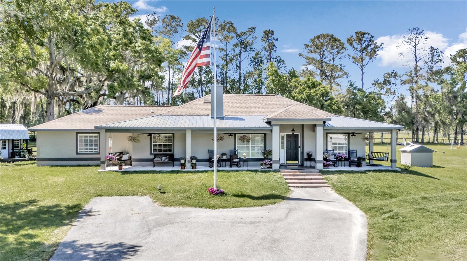 Welcome to the epitome of equestrian living at the doorstep of the World Equestrian Center! Nestled across the street from this prestigious venue, this enchanting horse farm offers a rare opportunity to immerse yourself in the heart of the equestrian world. Spanning nearly ten acres of lush Florida pastures with gorgeous granddaddy oaks, this meticulously maintained property showcases a charming residence and an array of amenities tailored to the equestrian lifestyle. Boasting 2,106 square feet of living space, the home welcomes you with inviting ambiance and tasteful finishes. Featuring three bedrooms and two baths, extra large flex room, open floor plan, granite counters and stainless appliances. Ceramic tile runs through most of the home and travertine tile in the bathrooms. Cozy up by the fireplace in the spacious living area, creating a warm and inviting atmosphere for relaxing evenings. Step outside and you'll discover a fully functional equestrian facility designed to meet the needs of both horse and rider. There’s a ten-stall barn with two rooms under AC for tack, two wash racks, ten large turnout paddocks, and a jump field. The shop built in 2020 is 3600 square feet and mostly under air with additional lean-to space for storage on the back of the building. And chill out in “Andy’s Bar” after work in a spacious man cave inside the shop. Additionally, two "tiny houses" provide cozy accommodations for barn staff or guests, and two RV hookups as well. Roof and HVAC replaced in 2017.