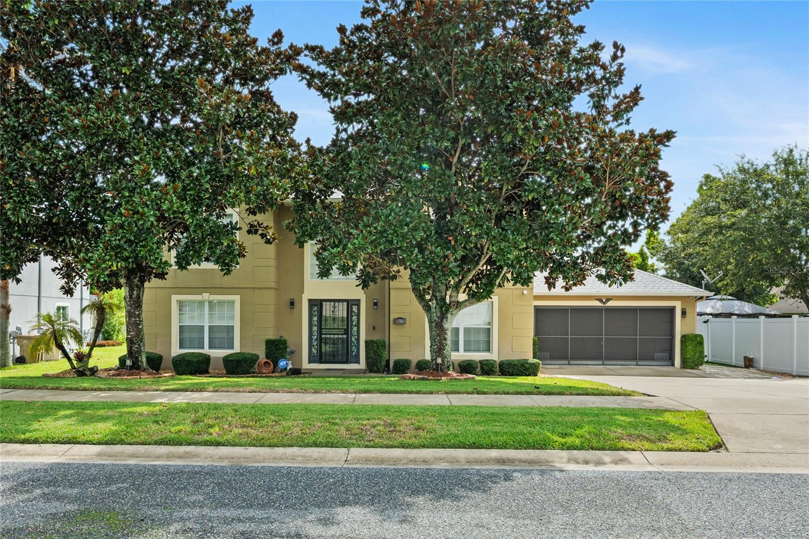Welcome to Your Dream Home in Leesburg, Florida! Located in the heart of Lake County, this beautiful property offers everything your family has been searching for. Enjoy peaceful neighborhoods, fantastic restaurants, and access to the gorgeous Harris Chain of Lakes—all just minutes away. This spacious 4-bedroom, 2.5-bath home is move-in ready with modern updates and plenty of space inside and out. The 2023 roof, 2025 water heater, and 2020 AC provide peace of mind for years to come. Step inside to soaring ceilings and a stunning staircase that creates an immediate “wow” factor. The first floor boasts a formal living room, formal dining room, and a large family room that flows seamlessly into the chef’s kitchen—complete with solid wood cabinets, granite countertops, a large island, and stainless steel appliances. Upstairs, the master suite is a true retreat with a large walk-in closet and a spa-like bath featuring a garden tub, extended vanity, and separate shower. Each additional bedroom offers comfort and privacy, while the open hallway overlooks the welcoming foyer below. Out back, the enclosed Glass Lanai is perfect for family gatherings, while the expanded outdoor sitting area provides the ideal space for relaxing or grilling. The landscaped backyard is lined with fruit trees and includes a spacious shed for storage, tools, or toys. This Property also has a large 2 car garage with side parking for a boat or trailer. Lovingly maintained from top to bottom, this home is ready for its next family. Once you see it, you’ll fall in love!