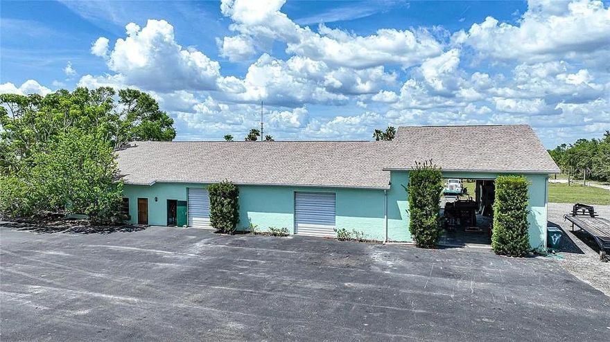 CAR LOVERS DELIGHT! FLEXIBLE COMMERCIAL SPACE! This versatile building contains a total of 7,200 sf including a 900 sf air-conditioned hobby shop with full bath, 900 sf of office space with 3 rooms and a ½ bath plus a 5,400-sf garage/workshop with 8 overhead doors including 3 tall doors to accommodate RV’s. The shop features a 9,000 lb. auto lift and plenty of space to store and work on boats, trucks, classic cars and farm equipment. All walls are solid concrete, and the flooring is 6,000 lb. concrete, 6 inches thick with 30’ of raised concrete floor on the east end of the building. Brand new reinforced gable roof and garage doors were replaced approximately 10+ years ago with 150 mph impact doors. This building was built to service and operate a tree farm however it can be easily transformed for other commercial uses. Zoned RE1, agricultural and plenty of room to bring your horses and livestock. Seller is offering the adjacent custom-built 4-bedroom, 2.5-bath estate home featuring 3,645 square feet of thoughtfully designed living space for sale separately plus has 24 acres of contiguous vacant land available for sale separately also. Country living close to everything! A short ride to restaurants, shopping, Charlotte Harbor and downtown historic Punta Gorda with world-class fishing and boating, beautiful parks, community events and entertainment!