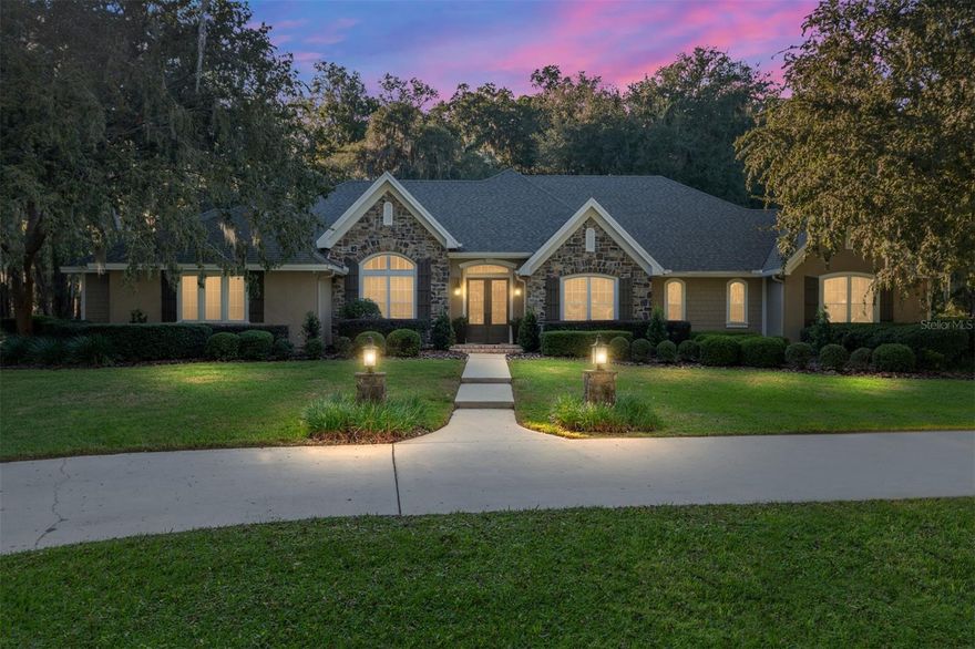 Welcome to this exquisite estate in the private, gated community of Tuscany Ridge, offering a perfect blend of sophistication, privacy, and convenience. Ideally located just 2 miles from I-75 and only 15 minutes to downtown Gainesville, this exceptional property sits on a five-acre park-like setting surrounded by lush, mature landscaping and majestic Granddaddy Oaks.

Step through the new grand 8-foot double French doors into a home that exudes timeless elegance. The interior features new wide plank white oak wood flooring, crown moulding, and beautiful trim details throughout. Light pours in from an abundance of windows adorned with plantation shutters, enhancing the home’s warm and inviting feel.

The spacious formal living and dining rooms are anchored by an impressive two-sided gas fireplace with marble tile and custom millwork, while the family room features a cozy wood-burning fireplace and built-in cabinetry designed to accommodate even the largest television. A built-in computer desk area adds a practical touch for work or study.

The chef’s kitchen is both functional and elegant, boasting custom cabinetry, quartz countertops, and a marble backsplash. Top-of-the-line appliances include a Kitchenaid 42-inch built-in refrigerator and a new Ilve 40-inch gas range with griddle, complemented by double ovens, a large walk-in pantry, and a convenient desk area. The laundry room features an additional refrigerator, LG washer and dryer, and abundant storage.

The primary suite is a true retreat with a tray ceiling, two large walk-in closets with built-in dressers, and an adjoining flex room perfect for a nursery, office, or fitness space. The updated primary bath offers a spa-like experience with a Jacuzzi tub, custom cabinetry, and elegant finishes. All bedrooms are generously sized with walk-in closets and beautifully updated bathrooms.

Enjoy year-round outdoor living on the huge covered porch with ceiling fans and wood-look tile flooring, overlooking serene wooded views. Additional features include a Trex deck, surround sound system (family room and back porch), and a gas grill hookup for effortless entertaining.

Car enthusiasts and hobbyists will appreciate the 3+ car garage with a workshop area, new Elastomeric epoxy-coated flooring, and a newly added workshop/storage space. There’s also access to a huge unfinished bonus room above the garage, ideal for future expansion. The garage is also equipped with an electric car charger hookup, ready for your EV.

Additional highlights include:

New roof and full exterior/interior paint

Dual-zone heat pumps and two water heaters (40 & 50 gal)

Water softener/filtration system

Recently updated septic drain field

10-zone irrigation system

Buried propane tank

Low HOA fees and energy-efficient systems

Every detail has been thoughtfully updated and meticulously maintained. This property truly captures the best of luxury country living just minutes from the heart of Gainesville.