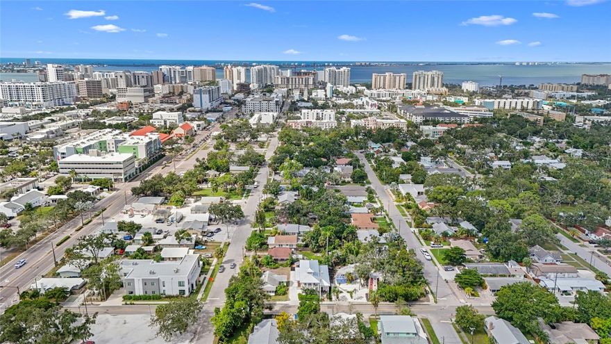 Experience elevated downtown living at this newly built residence just steps from Main Street. Designed and constructed by its owner with meticulous attention to detail, this 3,154 sq. ft. home blends timeless architecture with modern performance—built on 16-gauge steel framing with the finished floor 23 feet above sea level and more than 10 feet above the floodplain in coveted Zone X. Inside, 10-foot ceilings, three solid walnut arched exterior doors, and 8-foot interior doors set the tone for exceptional craftsmanship and scale. The open-concept layout connects the living, dining, and chef’s kitchen, featuring polished marble countertops and backsplash, a 10-foot marble island, 48” Thor natural gas range with double oven, Miele dishwasher, dual 32” Electrolux refrigerator and freezer, and a walk-in pantry. The home also includes a reverse osmosis under-sink system and whole-house water filtration, reflecting an attention to detail rarely found in new construction. The first-floor primary suite offers a private patio overlooking the saltwater pool and a spa-inspired bathroom with dual closets, a freestanding soaking tub, dual sinks, and a walk-in shower. Upstairs, three en-suite bedrooms include one with French doors opening to a private balcony, perfect for enjoying downtown sunrises with a cup of coffee and evening breezes. Every finish, from the arched thresholds and French doors to the curated lighting and custom cabinetry, reflects a home designed without compromise. Outdoors, the fenced backyard delivers a private resort-style retreat with a heated saltwater pool, pavered surround, and entertaining area framed by tropical landscaping. A dog run with a built-in dog door adds convenience for pet owners, while the flexible rear space has been thoughtfully designed to accommodate a future accessory dwelling unit (ADU)—with architectural plans available upon request. With hurricane-rated impact casement windows, a standing seam metal roof, and hard-wired Arlo video entry, this home combines peace of mind with modern luxury. Located in Sarasota’s Downtown in the beautiful Gillespie Park neighborhood, this home offers the best of city living—walkable to restaurants, theaters, and the waterfront, yet privately tucked away just minutes from Marina Jack, The Bay, Payne Park, and the beaches of Siesta and Lido Key.