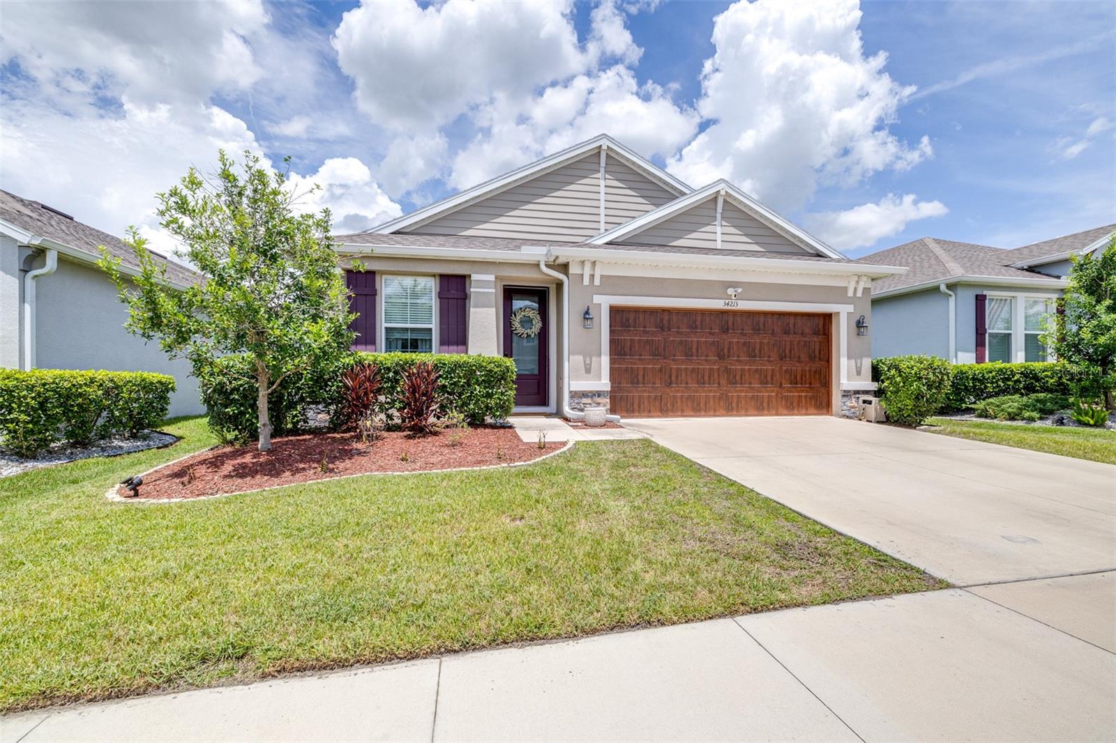 Nestled in the desirable community of Watergrass, this 2021-built home has a 2021 electric golf cart included with any accepted offer before September 5th! Offering 3 bedrooms, 2 bathrooms, and an open floor plan, this home is perfect for families! A great room for dining and family gatherings is in the center of the home. Additional spaces include a versatile flex room, a quiet office, and a screened patio perfect for enjoying the view of the expansive, fenced backyard. The kitchen features 42-inch wood cabinets, quartz countertops, stainless steel appliances, and a convenient eat-in breakfast bar. The great room offers enough space for a dining table that seats 6 to 8 people, alongside your favorite living room furnishings. The master bathroom is equipped with a walk-in shower, rain head and wand shower heads, dual sinks, and a private water closet. The secondary bath includes a tub-shower combination for versatility. Laminate wood-look flooring extends throughout the main living areas, with carpeted bedrooms and tile in the bathrooms, kitchen, and laundry room. The laundry space offers built-in cabinetry for extra storage. The garage is thoughtfully equipped with hanging shelving, a Tesla EV charger, and built-in stairs to the attic. The exterior boasts new built-in Govee LED lights, allowing you to illuminate your home in any color you choose. Come check it out and enjoy the golf cart for drop off/pick up at school or head to the nearby Publix! This home is within one of the top school districts in Pasco County and is conveniently located near all that Wesley Chapel has to offer. Just 10 minutes from I-75, you can reach Tampa in about 30 minutes.