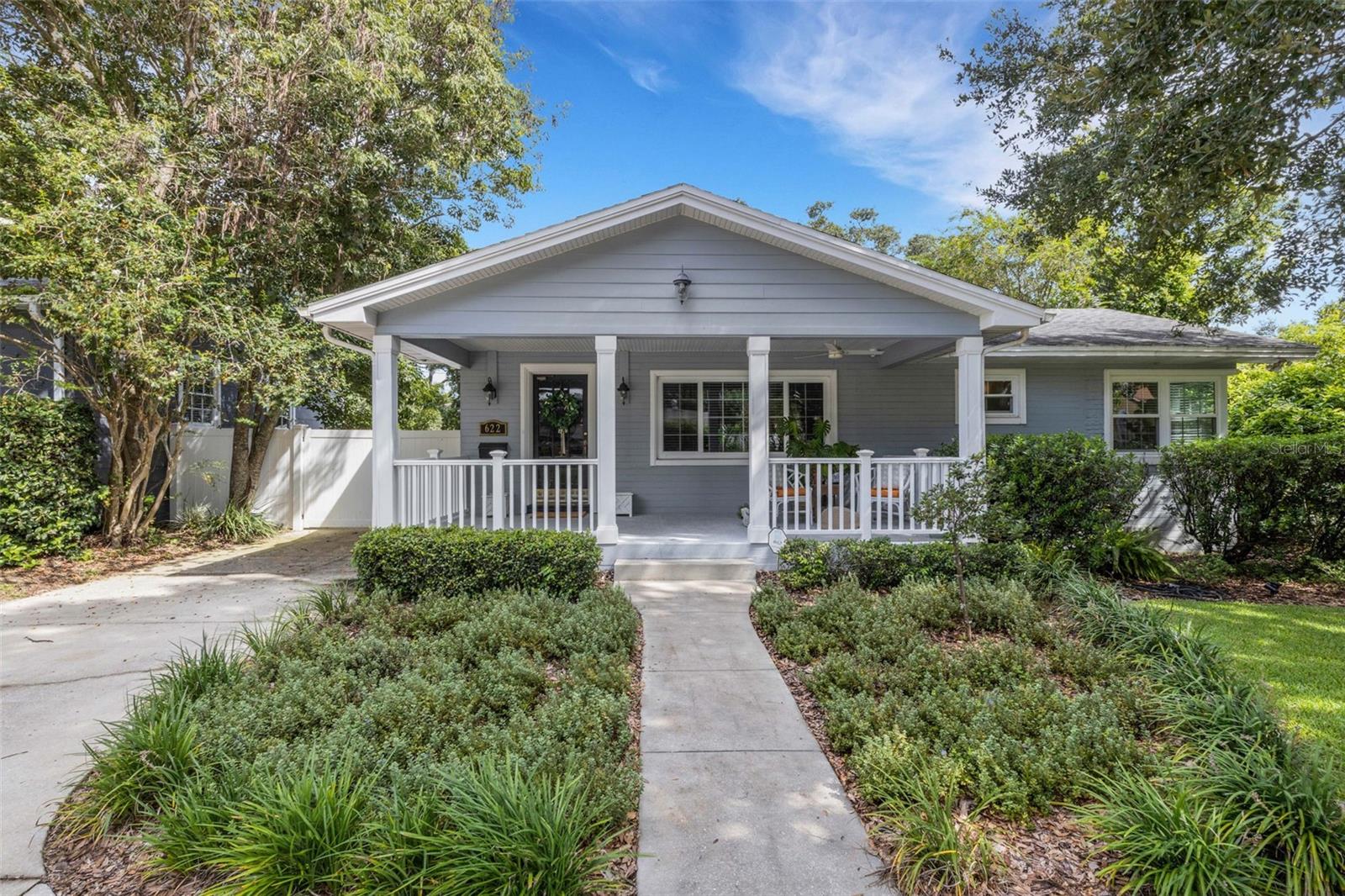 Welcome to the heart of Lakeland! Just steps from Lake Hollingsworth and set along a charming brick street shaded by mature trees, this updated home captures the perfect blend of character and convenience. Relax with a glass of sweet tea on the inviting rocking-chair front porch before stepping inside to discover a light, bright, and open floor plan.
Offering 3 bedrooms and 2 baths with a desirable split layout, the home features a spacious great room, a formal living room, and a kitchen/dining combination perfect for gatherings. The updated kitchen shines with granite countertops, stainless steel appliances, and timeless details like crown moulding, chair rail, and gleaming wood floors.
The private primary suite is a true retreat, boasting new custom built-ins, a fully updated ensuite bath with granite counters, walk-in shower, and an organized walk-in closet. The hall bath also impresses with a brand-new vanity and plenty of storage.
Outdoors, the entertainment-sized backyard is designed for Florida living—lush landscaping, a white privacy fence, and both a brick paver patio and a separate stone seating area offer multiple spots for entertaining. A she-shed/man cave with 252 sq ft plus A/C and electric is ideal for a home office, studio, or hobby space.
Practical updates include new windows (2025), a new electrical panel, and a new AC (2025). Parking is a breeze with a circular front drive plus an additional side driveway.
All this in the sought-after Cleveland Heights area—central to shopping, dining, schools, golf, and all that Lakeland has to offer.