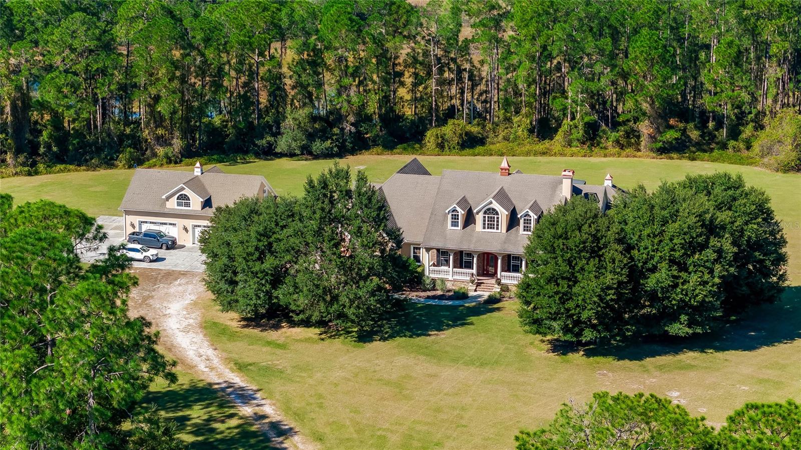 40 acres + One of a kind luxury custom home! This custom home offers the beauty of luxury living with the added advantage of absolute
privacy. Situated on 40 acres of landscaped grounds, the property provides a serene retreat from the hustle and bustle, creating a haven of
tranquility. Despite its secluded setting, accessibility is not compromised. The estate enjoys easy access to a major highway, ensuring that the vibrant energy of Central Florida, including the magic of Disney just 30 minutes away, the vibrant city of Orlando within a 30-minute drive, and the convenience of Orlando Airport reachable in 40 minutes, is within effortless reach. This unique combination of seclusion and accessibility defines the property's charm, offering an exclusive retreat while maintaining convenient connections to the region's key destinations.
Introducing a masterpiece of luxury living in Central Florida. This custom home was crafted by one of the region's foremost luxury homebuilders as their personal residence and is now available. Property is secured by a fenced perimeter and a private gated entry, ensuring absolute privacy and tranquility. Once you see the gate start opening you don't only feel at home, you start driving into your own oasis. The mature landscape welcomes you and opens the path to the spectacular house. The estate comprises a main residence, a detached garage with Guest/In-Law Quarters above, and a barn storage building, offering a harmonious blend of opulence and functionality.
Spanning over 7800 square feet of living space, this residence is a showcase of unparalleled design and meticulous attention to detail. The interior boasts a Bonus Room with an antique built-in Bar/Saloon, an Exercise Room, four bedrooms, 4.5 Bathrooms, and an array of thoughtful features that redefine luxury living. With beautiful built-in custom closets, and hardwood floors throughout, each element has been carefully curated to create an ambiance of refined elegance. Entertain in style with the Pool Cabana and the inviting Pool, perfect for hosting gatherings or enjoying peaceful moments in a resort-like setting.
The kitchen is a chef's dream, equipped with Wolf & Sub Zero appliances, hidden walk-in pantry, and Wellborn cabinets. The Guest/ In-law quarters is a one-bedroom apartment fully equipped with kitchen and laundry room inside. The built-in open tree house adds a playful element to the expansive 40-acre property, offering a tranquil escape amidst nature's beauty. Whether used as a scape, a play area, or a captivating spot to enjoy the surrounding scenery, it is a charming addition. Once-in-a lifetime opportunity! Take it!
