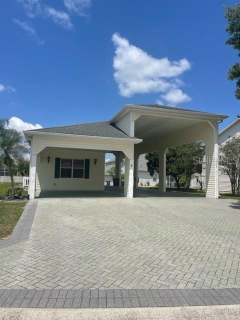 BETTER NEWS...WE JUST PUT NEW PRICE ON THIS GREAT PROPERTY!! GREAT NEWS!!! THE OWNERs HAS JUST PUT A NEW ROOF ON! IT LOOKS GREAT They also had a wind mitigation and 4pt inspection. ALL IS GOOD!! This property is perfect for RV owners that own even the largest of RVs to park in a very large RV port, with ample room for slides to be open and plenty of room to walk around them. This well appointed efficiency home comes complete with everything you need to enjoy the RV lifestyle in a unique RV community. This is home is a dream come true for RV full-timers or seasonal travelers. It is the largest Egret model, making it a one of a kind within this unique RV port home community in Central Florida. The RV port is 17.5 feet wide by 70 feet long and has 50 amp plugs on both sides of the RV port to accommodate either a pull-in or back-in approach to park. A nice carport allows for your car and golf cart to be under cover. The kitchen is spacious with beautiful oak cabinets with crown molding and has lots of storage space. A pantry large enough for kitchen necessities within the kitchen area. An open floor-plan, (which is so popular today), combine a sitting area with a sofa and 2 chairs, with plenty of room for the queen pull out sofa-bed which is air inflated for flexible firmness. as well a dining room large enough break-bread with 6-8 friends and neighbors at a expanding dining table. The full bath is well appointed with large walk-in shower and linen closet. Enjoy entertaining as many as 12 friends on the screened lanai. Laundry is easy and convenient in your own washer/dryer and mop sink all contained in a laundry closet. You have just found a great RV community, with 24 hour security, two clubhouses both with heated pools. Between the two clubhouses you can enjoy spas/billiards/laundry facilities, exercise rooms, movie theater, pickle courts, card rooms and there is always a jigsaw puzzle being worked on by neighbors all the time. Look no further! You have found paradise in this RV up scale community where everyone has common interest. We all are RVers that like to travel, enjoy our fellow neighbors and meet up with them around the country as you make new friends here and while on the road. Entertain outside the RV, host family and friends who visit or just relax and enjoy being out of the RV once in a while in your own space.
