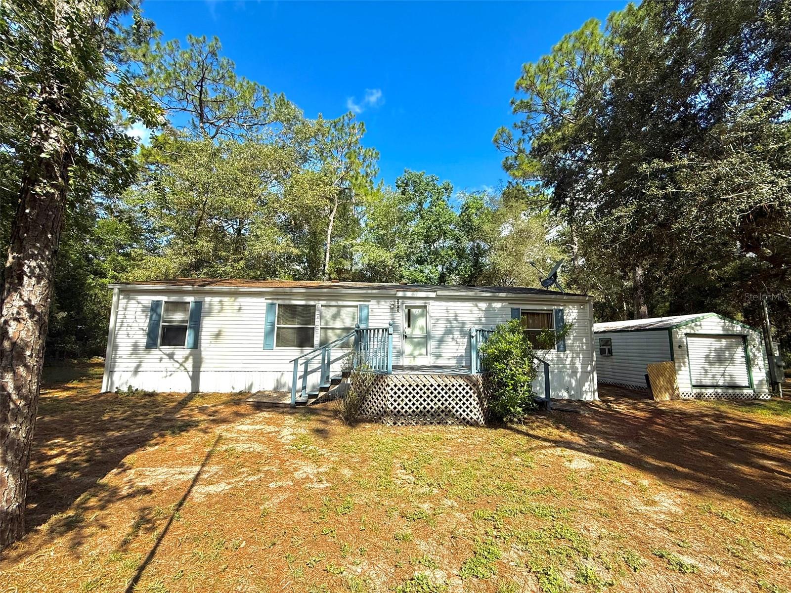 Welcome to this 3-bedroom, 2-bathroom mobile home located on a generous 0.76-acre lot in a peaceful setting. The entire property is fully fenced with two front gates, offering both privacy and convenience. Two solid sheds are included—one wired with electricity—perfect for storage, a workshop, or hobby use. Step out back to a spacious wooden deck, already wired for ceiling fans and lighting, making it an ideal space for relaxing or entertaining. Inside, the home offers a comfortable layout with good space throughout. While it could use some updates and TLC, it’s a great opportunity for someone ready to make it their own. Located just 10 minutes from the crystal-clear waters of Rainbow River, 15 minutes from the World Equestrian Center, and close to all major shopping and amenities—this property combines space, potential, and convenience in one package. The roof is in good condition with no known leaks, giving you added peace of mind.
Contact me today to schedule your private showing!