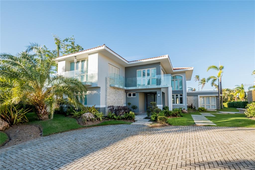 This stunning and spacious property has 5 bedrooms, 6.5 bathrooms and 5,299 sq. ft. and is located in Dorado Beach East community. This modern property features a magnificent pool, private backyard, high ceilings, and spacious kitchen with top of the line appliances.
The Dorado Beach East community is private, gated, family friendly and offers a wide range of facilities that you can enjoy. The facilities include scenic pools, clay tennis courts, basketball and beach volleyball courts, a basic gym, a game room, a 3-par golf course that winds through the neighborhood, and an aviation themed park which has a custom water park and sand park.
Located within the Dorado Beach Resort, since it is a 2,000-acre natural reserve most of the communities are 1-3 miles away from the beach and Hotel. This being said, the entire resort is interconnected via golf cart trails, meaning that you can have easy access (walking or in golf cart) to the different communities and amenities within this Resort.