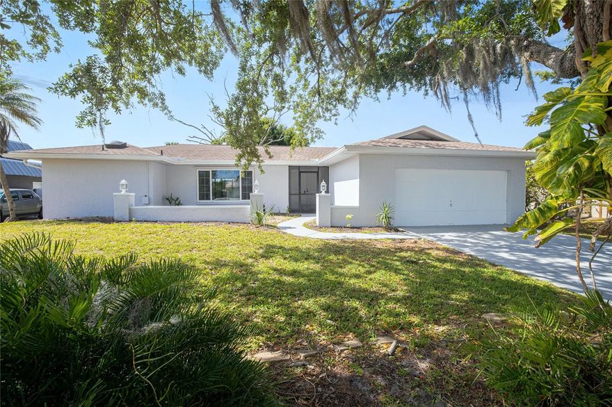 Located at 22457 Oceanside Ave, Port Charlotte, FL 33952, this MODERN updated Southwest Florida residence offers a light-filled OPEN FLOORPLAN designed for effortless flow, expansive living spaces and updated TILE FLOORING and CONTEMPORARY finishes and fixtures.  The interior layout is designed for functionality and everyday living, creating a welcoming atmosphere ideal for entertaining or quiet enjoyment.  The modernized kitchen features GRANITE COUNTERTOPS, stainless steel appliances, white cabinetry, and a casual dining area that blends seamlessly into the main living space. A highly desirable SPLIT BEDROOM DESIGN provides privacy and flexibility for guests or family members.  Additional highlights include UPDATED BATHROOMS with touch mirrors, HURRICANE SHUTTERS, and a 2021 ROOF.  Situated in FLOOD ZONE X, this property does NOT require flood insurance, creating added affordability for homeowners and investors.  Enjoy outdoor living with an OVERSIZED SCREENED LANAI overlooking a large backyard for entertaining.  Whether searching for a primary residence, seasonal Florida retreat, vacation property, or income-generating investment, 22457 Oceanside Ave, Port Charlotte, FL 33952 presents a MOVE-IN READY opportunity in one of Southwest Florida’s most convenient and desirable locations.