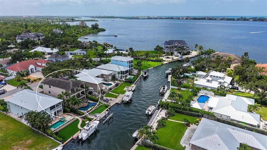 This masterfully constructed and impeccably maintained all block waterfront smart house is appointed with finest quality in every detail and is offered turnkey furnished. The spectacular heated infinity pool & spa won an award for “World's Most Amazing Pools” in 2014. Pool area has a “sunken living room” surrounding a firepit, waterfall pergola constructed of Western Red Cedar. Located on excellent boating water, only 4 houses away from Little Sarasota Bay with boat dock, 10,000lb lift and no fixed bridge to Gulf, this home is a boater’s paradise. The interior is luxuriously trimmed throughout with designer ceilings, gorgeous destressed DuChateau European Oak flooring, Albrecht wood cabinetry, stone and reclaimed wood details and a beautiful commercial-grade elevator. The main living area on the 2nd floor offers a study/den, dining room, full bath, a fantastic open gourmet kitchen, great room with wet bar and it opens out to a large deck with outdoor kitchen/BBQ and amazing partial bay views. An outdoor spiral staircase leads to pool and dock. The primary suite with coffee bar, large en-suite bath, spacious closet is located on the top floor and leads out to a large private veranda with breathtaking sunsets overlooking Sarasota Bay. The two guest rooms with jack & jill bath and the laundry room are also on the top floor. All windows, doors and sliders are impact hurricane resistant, spray foam insulation in attic, underground drainage, smart house features with security system. 4-car tandem garage with storage and work bench area. No storm damage whatsoever! This home is currently the best waterfront value in the area. Contact us for a private showing.