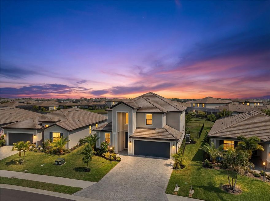 Welcome to refined, resort style living in one of Lakewood Ranch’s most sought after gated communities, where space, style, and everyday comfort come together seamlessly in this beautifully designed five bedroom, three bathroom residence in Lorraine Lakes. Thoughtfully designed for both comfort and functionality, this spacious home offers a desirable layout featuring a first floor bedroom and full bath ideal for guests, multigenerational living, or a private office, while the primary suite and additional bedrooms are privately situated upstairs alongside a versatile loft space. The main living area showcases an open concept design filled with natural light, enhanced by soaring ceilings, expansive tile flooring, and seamless indoor outdoor flow overlooking peaceful water views. The chef’s kitchen is both stylish and functional, complete with crisp white cabinetry, quartz countertops, stainless steel appliances, a large center island with seating, and a walk in pantry, all opening to the dining and living areas perfect for everyday living and entertaining. The primary suite offers a relaxing retreat with generous space, a spa inspired bathroom, and ample storage, while the upstairs layout provides flexibility for a variety of lifestyles. Step outside to a covered and screened lanai where tranquil lake views create the perfect backdrop for morning coffee or evening relaxation. Residents of Lorraine Lakes enjoy an exceptional resort style lifestyle with amenities including a grand clubhouse, resort pool with cabanas, lap pool, state of the art fitness center, indoor basketball and volleyball courts, tennis and pickleball courts, playground, splash park, arcade, social director, and an on site restaurant and bar. Ideally located in the heart of Lakewood Ranch, this home offers convenient access to top rated schools, shopping, dining, golf courses, and is just a short drive to the world renowned beaches of the Gulf Coast including Anna Maria Island, Siesta Key, and Lido Key, as well as Sarasota, Bradenton, St Petersburg, and Tampa. This is a rare opportunity to enjoy luxury, space, and resort style living all in one exceptional home.