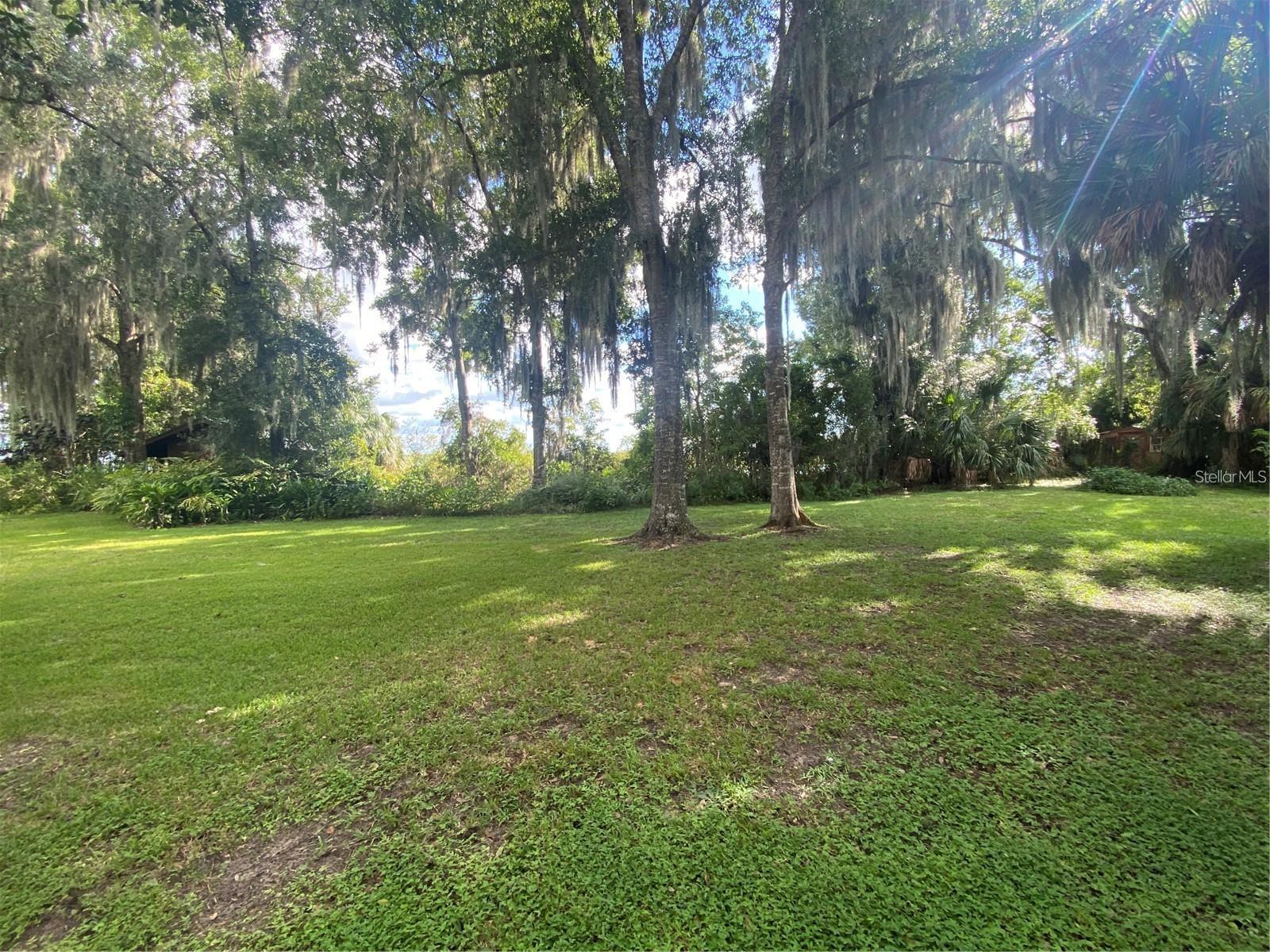 A little over an acre of land on Lake Reedy inside the City Limits of Frostproof. Two storage sheds are included with the purchase. This lot has a flood zone of AE. Previous prospective buyer has completed due diligence and discovered via phone calls and emails with governing authorities and they concluded the land size wasn’t conducive for them to build their home. It is highly advisable le to check with all. Building regulations of what it takes to build in this zone. There is a marked base flood elevation for this lot, any living areas needs to be built above that area and flood vents are to be installed underneath the structures in case of flooding. Please check with all regulations and set backs. Lake Reedy is a very large 3600+/- acre lake it has a FAA identification for water float planes to land and takeoff. Lake Reedy is know for lots of Bass and other fishing, boating and skiing. Southwest Florida Water Management District will be the one to make the determinations of the conditions of the property and the requirements. Please understand this lot is MOST LIKELY unbuildable. This lot is covered in wetlands.
