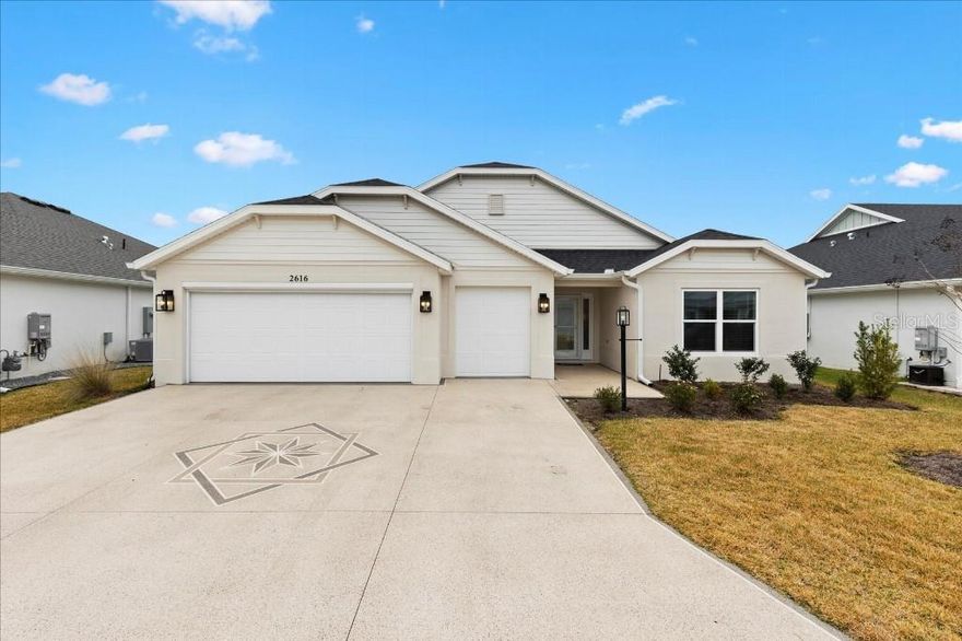 This beautiful Veranda-style home offers 1,953 square feet of living space and includes a two-car garage along with golf cart garage equipped with remote access. Attic stairs provide convenient additional storage. The garage features an epoxy-coated floor, and the driveway has been painted for a well-maintained appearance. The home is ideally located just two minutes from Brownwood Paddock Square  while offering a quiet setting, free from turnpike noise. Additional upgrades include a front door with a glass insert, screen doors throughout, and a renovated laundry room with a stacked washer and dryer (wash tower). The property is also equipped with full perimeter gutters and a screened-in lanai with glass sliders, perfect for relaxing or entertaining. Also an enclosed back yard, perfect for pets!