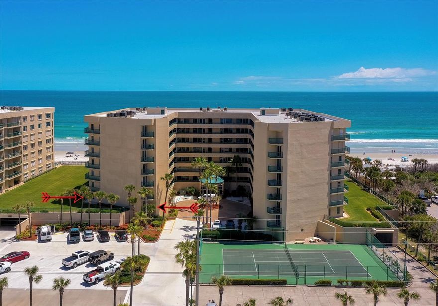 This well maintained 2-bedroom, 2-bath condominium in the gated, oceanfront community of Towers at Ponce Inlet offers 1,500 square feet of bright, open living space with direct beach access and resort-style amenities, and is fully furnished for your immediate enjoyment. A welcoming entry leads into a spacious open-concept layout where the living and dining areas are filled with natural light from large sliding glass doors. The well-appointed kitchen features abundant cabinetry, expansive counter space, a functional layout, and a breakfast bar for casual dining, along with a charming breakfast nook surrounded by windows. The spacious primary suite provides a comfortable retreat, featuring a walk-in closet and an en-suite bathroom with an oversized vanity, soaking tub, and separate glass-enclosed shower. An additional bedroom offers flexibility for guests or a home office and includes sliding glass doors that open to a private balcony. A second full bathroom and in-unit laundry add everyday convenience. The sunroom is a standout feature, offering expansive windows, abundant natural light, and a versatile space to relax while enjoying seamless indoor-outdoor living. Outdoor features include a private balcony overlooking lush landscaping and palm trees, along with access to a large patio area overlooking the beautifully maintained community grounds leading directly to the beach. The first-floor location makes this unit especially appealing for pet owners, offering the convenience of stepping directly from your sliding glass doors onto a lush, open lawn. This residence also includes secure, assigned underground parking. Residents of this gated oceanfront community enjoy an exceptional range of amenities, including a beachfront pool and spa, fitness center, clubhouse, tennis courts, BBQ area, car wash station, and private beach access. With beautifully maintained grounds and a prime oceanfront location, this fully furnished property offers a true coastal lifestyle in Ponce Inlet. All information recorded in the MLS is intended to be accurate but cannot be guaranteed.
