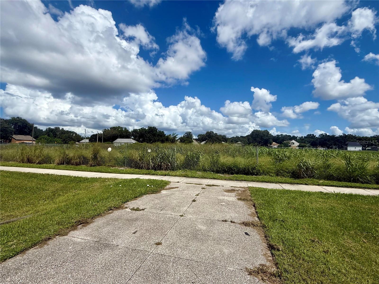 Amazing opportunity to own a highly visible Comercial site in a thriving location! Situated directly on Pine Hills Rd , just north of Clarcona Occoe rd , this property is excellent frontage , access, and exposure . Zonning -Comericial , Site Potential - Accommodates up to 8000 sq.f of buildings with required parking . Possibility to build one or two building with parking in between . Attractive pond view , surrounded by a large retention pond that simplifies future development. Electric , water and sewer nearby. Boundary survey, topographic survey , and lot study available upon request. This site is ideal for a wide range of uses , including a retail store , daycare center , urgent care , or other service-oriented businesses. The location is unbeatable -across from newer large apartment complex , minutes form Walmar Groceries , and surrounded by dense residential neighborhood, shopping and entertainment options. High traffic and strong demographics make this a fantastic development opportunity