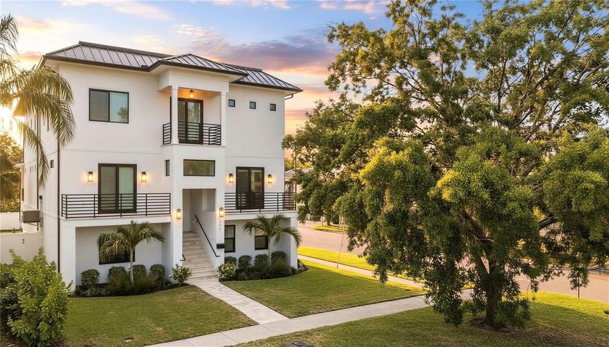 Elevated Luxury Meets Coastal Peace of Mind! Welcome to the pinnacle of modern coastal living, this fully completed Davis Islands residence offers a rare opportunity to own a NEW CONSTRUCTION and MOVE-IN READY home without the wait, stress, or surprise costs of building. Thoughtfully elevated 17 FEET ABOVE SEA LEVEL, this home was designed with resilience and a focus on long-term peace of mind. The entire bottom level of the home is dedicated to over 2,000 SQUARE FEET OF GARAGE & STORAGE SPACE that can accommodate PARKING OF 4+ CARS plus a separate GOLF CART PARKING GARAGE, keeping all primary living areas well above the minimum Base Flood Elevation requirement. With IMPACT RATED WINDOWS & DOORS throughout, you can rest easy knowing your home was built to the highest safety and efficiency standards. Inside, rich wood floors, soaring ceilings, and hand-selected designer finishes define a sophisticated yet comfortable living environment. The show-stopping kitchen boasts bespoke cabinetry, premium quartz countertops, and top-tier appliances—an ideal space for both hosting and everyday living. Spa-like bathrooms feature custom vanities and luxurious stonework, while an ELEVATOR conveniently connects ALL THREE LEVELS from the GARAGE TO THE TOP FLOOR. Outdoor living is just as exceptional, with a HEATED SALTWATER POOL & SPA surrounded by an expansive travertine paver patio, perfect for private lounging or entertaining guests. For multigenerational living or extended stays, a SECONDARY PRIMARY SUITE offers flexibility as a comfortable IN-LAW OPTION. Top it all off with a ROOFTOP TERRACE where you’ll enjoy BREATHTAKING VIEWS of the downtown Tampa skyline and watch cruise ships sail by. Whether you're sipping your morning coffee at sunrise or enjoying cocktails at sunset this rooftop destination might just become your favorite peaceful escape from the daily grind. Just one block from the vibrant heart of Davis Islands Village, you’ll find boutique shops, beloved restaurants, ice cream shops, and local favorites all within an arm's throw away. This home is more than a residence... It’s a secure, move-in-ready coastal retreat that offers elevated living in every sense.