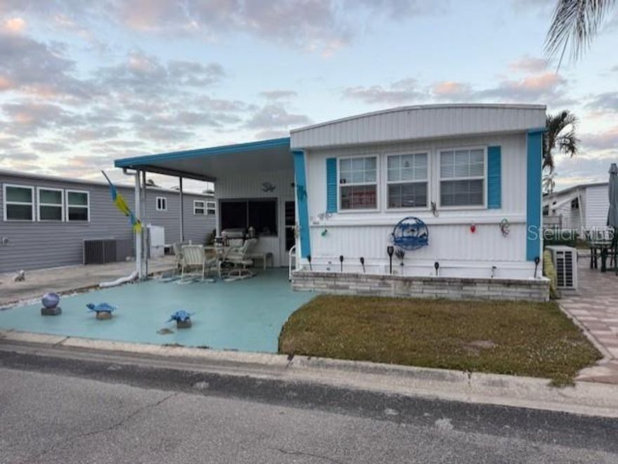 This 14-ft-wide manufactured home offers 1 bedroom and 2 full bathrooms, both updated with walk-in showers and new vanities. The kitchen features new countertops and opens seamlessly into the living room, creating an open-concept space with high ceilings and abundant closet storage. A spacious Florida room adds extra living area, while the utility room includes a washer and dryer. The property provides parking for two vehicles at no extra cost and comes furnished with three queen beds, a 65-inch TV, and patio furniture. Situated in a gated community, residents enjoy amenities such as a pool, shuffleboard, pickleball, a fitness center, clubhouse, and library.