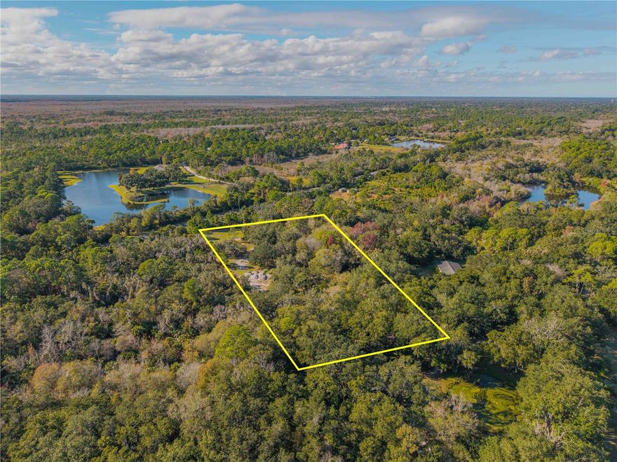 Build your dream home tucked away, beneath a canopy of mature Florida trees, this 3.40-acre fenced parcel offers a rare opportunity to own an authentic piece of Old Florida. Private, peaceful, and naturally beautiful, the property provides an ideal backdrop for a custom country estate/family compound, weekend retreat, or thoughtfully designed Barndominium.  Here, mornings begin with quiet breezes and birdsong, and evenings settle beneath wide open skies—yet you’re never far from modern conveniences. Enjoy easy access to shopping, local waterways, fishing, boating, pristine beaches, NASA, and Central Florida’s renowned attractions. This location delivers the freedom of rural living paired with everyday accessibility. Zoned RT within the City of Edgewater, this parcel invites you to bring your vision to life in a setting that feels far removed from the rush, while still connected to everything that makes the area so desirable. Expand your possibilities another 3+ acres, as this property is contiguous to 0 Clinton Cemetery Rd MLS NS1086813. Opportunities like this—where privacy, natural beauty, and location converge—are increasingly rare.