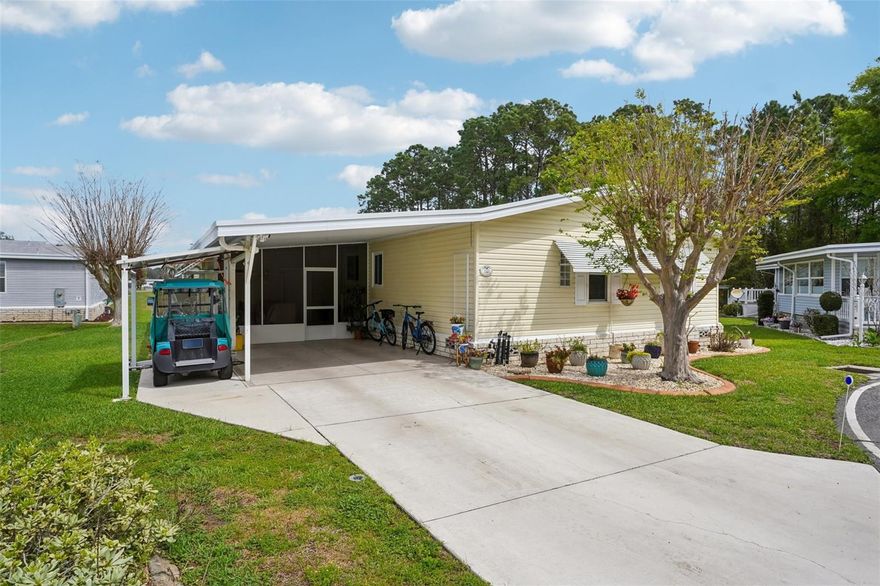 This move-in-ready home showcases numerous upgrades, including a modern kitchen featuring quartz countertops, Cabinets have pull outs, soft-close drawers with under-cabinet lighting, and stainless steel appliances. Lighting is conveniently adjustable throughout the house thanks to dimmer switches, letting you select bright or subdued illumination as needed. Both the kitchen and second bathroom are enhanced with skylights, and USB outlets in the kitchen add extra convenience.
An oversized flex room, currently serving as an inspiring art space, offers panoramic windows that overlook a picturesque pond. This area stands out as the highlight of the home—a must-see if you appreciate a room with a view.
Adjacent to the flex room is an office space, which leads to custom storage shelving filled with large, lidded plastic tubs. The property also boasts a spacious 14 x 32 workshop, complete with heating, cooling, and a utility sink. Ample storage solutions and efficient organization make this workshop exceptionally functional.
The primary bedroom is distinguished by custom ceilings and ample closet space, while its en-suite bathroom includes a walk-in shower and contemporary finishes. The second bedroom features additional custom storage doors above the closet. Bathrooms have Granite Counter tops and Tiled Floors. 
All these enhancements, thoughtfully designed by the current owners, create a unique blend of enjoyment and practicality. Recent updates include a new roof scheduled for installation in 2025, an HVAC system from 2020, a water heater provided in 2017, and durable laminate/vinyl flooring.
( The Community) Hawthorne at Leesburg is a resident-owned cooperative, gated 55+ waterfront community, renowned for landscaped grounds,ponds with illuminated fountains, a clubhouse offering more than 100 activities, a fitness center, swimming pools, a private marina with over 120 slips, and a budget-friendly $397 monthly fee. This fee covers water, lawn maintenance, emergency services (with on-site medics responding to button alerts in each home when residents require assistance), as well as RV and boat storage.