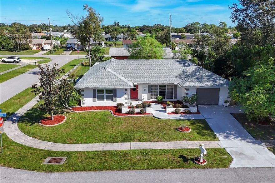 Tucked into an established North Port neighborhood, this spacious 3-bedroom, 2-bath pool home sits proudly on a beautifully landscaped corner lot where mature greenery creates a sense of privacy and calm the moment you arrive. With no HOA, no flood zone, and public water and sewer, this is Florida living without the fine print. Step inside to a bright, welcoming layout anchored by a well-appointed kitchen, overlooking the pool area, and featuring a generous closet pantry. The primary suite feels like a true retreat, offering direct access to the lanai and a walk-in tiled shower designed for comfort and ease. Out back is where this home truly shines. The large screened pool lanai is a peaceful escape, ideal for morning coffee, evening swims, or relaxed gatherings with friends. Lush landscaping frames the space, creating a tranquil, private atmosphere that feels worlds away from the day’s noise. A new pool pump keeps everything running smoothly, so you can focus on enjoying the moment. Recent upgrades add confidence and value, including A/C systems replaced in 2020 and 2021, a 2023 roof, and updated electrical. The former garage has been thoughtfully converted into a versatile den, perfect for a home office, media room, or hobby space, with additional storage tucked neatly behind the original garage door. A 2-car carport provides ample covered parking. Convenience is right outside your door with public transportation nearby, a community park close by, and Warm Mineral Springs just minutes away. You are also near shopping, dining, top-rated schools, CoolToday Park, Wellen Park, beaches, Port Charlotte Mall, and major routes including I-75 and U.S. 41. Peaceful, practical, and perfectly positioned, this home offers the space, upgrades, and outdoor serenity that make everyday life feel like a getaway.