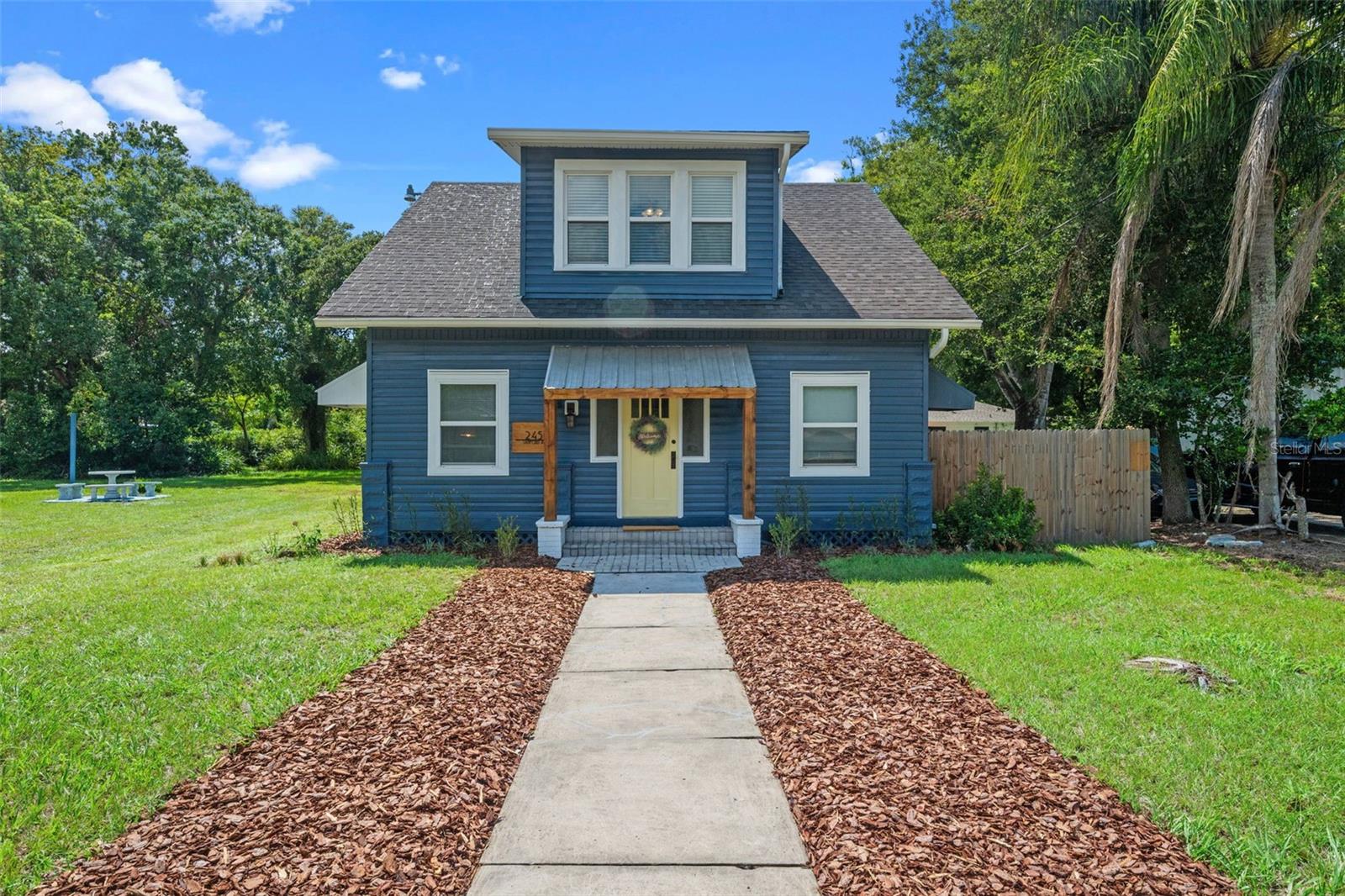 CHARACTER, CHARM, HISTORY & OPPORTUNITY in the HEART OF SANFORD! Step back in time and fall in love with this 1932 CHARMER that perfectly blends HISTORIC CHARACTER with thoughtful MODERN UPDATES. This three-bedroom, two-bathroom home sits proudly on an OVERSIZED LOT and offers not only WARMTH and CHARM but also rare flexibility with MIXED-USE ZONING and future DEVELOPMENT POTENTIAL. As you enter, you’re welcomed by a LIGHT-FILLED ENTRYWAY that can serve as a sunroom, drop zone, or cozy sitting nook—the perfect spot for your morning coffee. To the left, a charming door opens into a quiet OFFICE SPACE, ideal for working from home or curling up with a book. From there, step down into your spacious family room, anchored by a WOOD-BURNING FIREPLACE and filled with possibilities for entertaining, relaxing, or gathering with loved ones. Just off the living room is a hidden STORAGE NOOK/CLOSET tucked under the staircase with original wood shelving. Flowing seamlessly from the family room is the dining room, RICH WITH CHARACTER—STRIKING WALLPAPER, WOOD TRIM, and STYLISH LIGHT FIXTURE that feels right at home. The UPDATED KITCHEN is a true centerpiece, featuring QUARTZ COUNTERS, NEWER STAINLESS STEEL APPLIANCES, SUBWAY TILE BACKSPLASH, a LARGE PANTRY, and BREAKFAST BAR. —combining modern convenience with timeless detail. The PRIMARY SUITE, tucked away at the back of the home, is a private retreat with a WALK-IN closet, beautifully RENOVATED en suite with DUAL-HEAD WALK-IN SHOWER, and DIRECT ACCESS to the COVERED PORCH covered and OUTDOOR UTILITY ROOM. Upstairs, two additional bedrooms each feature WALK-IN CLOSETS and ABUNDANT NATURAL LIGHT, along with a cozy landing area currently used as a reading nook. The OVERSIZED FULL BATHROOM includes DUAL SINKS, a TUB/SHOWER COMBO, and GENEROUS LINEN CLOSET. Beyond the walls of this beautiful home lies the best of SANFORD LIVING—just minutes from HISTORIC DOWNTOWN Sanford’s brick-paved streets, charming shops, local dining, breweries, and the scenic riverfront where you can stroll, bike, kayak, and enjoy year-round festivals. But what makes this property TRULY UNIQUE is its MIXED-USE ZONING. Whether you’re looking for a PRIVATE RESIDENCE, PROFESSIONAL OFFICE, or SAMLL STOREFRONT, the possibilities are wide open. Approved uses include options such as a boutique-style retail, small offices, or other light commercial businesses—perfectly suited for transitional residential areas. Additionally, while Seminole County recognizes this as one parcel today, the property was originally platted as three separate lots. Though the city administratively combined them in the 1980’s, records still show the original lot configuration. Through the City of Sanford, a new owner can apply to subdivide the land back into three parcels—creating opportunities for multiple residences or mixed-use spaces. Whether you choose to enjoy this HISTORIC HOME AS-IS, REPURPOSE it for COMMERCIAL USE or EXPLORE SUBDIVISION and DEVELOPMENT POTENTIAL, this property is TRULY A ONE-OF-KIND OPPORTUNITY in the HEART OF SANFORD. Welcome home to history, charm, and endless possibilities! ROOF-2011, AC DOWNSTAIRS -2020, AC UPSTAIRS-2021, HOT WATER HEATER -2014, ELECTRICAL AND PLUMBING UPDATED. CALL YOUR AGENT TODAY FOR A TOUR!