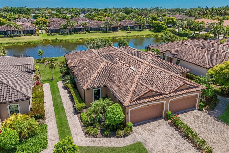 Beautifully maintained LAKEFRONT HOME with a fabulous lake view! With 1,639 square feet of living area, this thoughtfully designed residence features a private walkway to the front door. The front door has a sliding screen so you can enjoy the fresh Florida breeze. You enter this home and enjoy the very open great room accented by a high coffered ceiling. The design is the very popular Great Room open to the Kitchen floor plan. Separate Dining Room

also features a high coffered ceiling accent.

The kitchen is well-appointed with granite countertops, white cabinetry, stainless appliances, loads of kitchen cabinets and a pantry. The breakfast bar is ideal for casual dining or entertaining. There are two spacious bedrooms PLUS a den/office. Additional highlights include window blinds throughout, full patio slider vertical blinds, the den features a built-in home theater system with TV and surround sound and a Murphy bed for when extra guests visit! Enjoy the extended lanai
accented by brick paver flooring and a beautiful lake vista! Lanai patio furniture, some great room furniture and bedroom furniture is included in the sale price.  NEW hurricane rated windows plus the lanai has electric roll down hurricane protection. 2 car garage with storage shelves and pull down ladder with attic flooring for extra storage. This beautiful home is in close walking distance to the Clubhouse and resort pool.
Esplanade by Siesta Key is a gated, amenity-rich community with an on-site manager, clubhouse with scheduled activities, resort-style pool and spa, fitness center, tennis and pickleball courts, dog park, and outdoor gathering areas overlooking the lake. IMPORTANT: The HOA Fee includes exterior landscaping care AND exterior building Maintenance, and the use of all the Club Facilities!

Conveniently located near shopping, dining, and everyday conveniences, and just a short drive to Siesta Key Beach. Sarasota’s vibrant arts and cultural scene, along with nearby UTC Mall, provide endless options for entertainment and recreation.