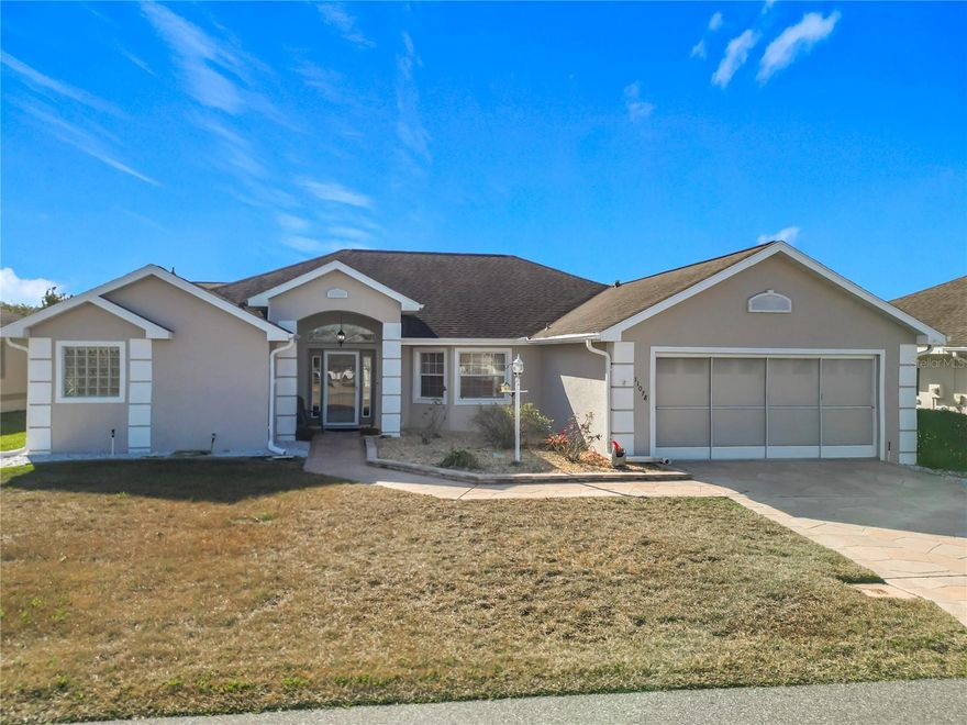 Discover this immaculate, well-maintained home in the premier Stonecrest 55+ gated golf community. Situated adjacent to The Villages, this spacious 1,972-sq.-ft. 3BR/2BA residence features an open-concept layout with vaulted ceilings, creating an inviting space perfect for entertaining. The spacious kitchen flows seamlessly into the dining and family areas, ensuring you are always part of the conversation. This split-bedroom floor plan offers a quiet retreat for guests, while the large primary suite features dual closets, an en-suite bathroom equipped with dual sinks, a soothing soaking tub, and a separate stand-up shower. The layout offers an easy indoor-outdoor flow, with sliding glass doors from both the living room and the primary bedroom leading to a large, window-enclosed lanai. Most furniture is available for purchase making it move-in ready!  
This community offers private golf cart access to Walmart, Aldi, Lowe’s, and local dining. Living in Stonecrest offers a resort-style experience with access to an incredible array of amenities. Stay active with 12 pickleball courts, shuffleboard, a dedicated softball field, bocce courts, tennis courts, and cornhole. The community is home to the Broad Stripes Golf Club and restaurant/bar, featuring a championship 18-hole course. With over 100 active social clubs and a full-time activities director, there is always something to do. Enjoy four swimming pools (including one heated indoor saltwater pool), a state-of-the-art fitness center, and a luxury clubhouse. With a low HOA fee, this property is located in one of Central Florida's most vibrant active-adult communities. Come check it out.