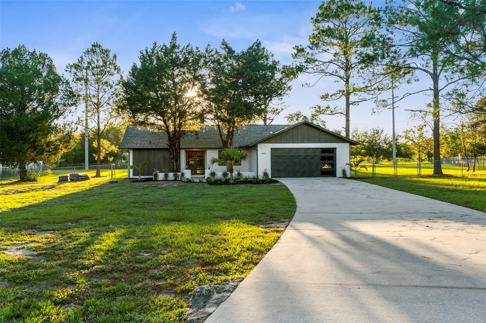 Welcome to 14335 Hammer Stone Lane – a stunningly reimagined farmhouse in the heart of Hudson, Florida. Set on nearly 1.5 acres of beautifully refreshed landscape, this home combines timeless charm with modern upgrades, offering the perfect blend of comfort, style, and peace of mind.
Step inside to discover a bright open floor plan with brand-new top of the line Luxury Vinyl Plank flooring, windows, and finishes that fill every room with warmth and natural light. The chef-inspired kitchen boasts all-new cabinetry, sleek quartz countertops & quartz backsplash, and stainless-steel appliances – perfect for creating meals while staying connected to the heart of the home. The office can easily be converted to a 4th bedroom, or a dining room depending on family needs.
Both bathrooms have been fully renovated with modern farmhouse touches, creating spa-like spaces for relaxation. The thoughtful updates continue throughout with a new roof, new AC system, new ductwork, and energy-efficient insulated double pane windows, ensuring worry-free living for years to come.
Outside, enjoy the beauty of fresh landscaping and wide-open space, giving you the freedom to garden, entertain, or simply enjoy the serenity of your own private retreat. With nearly 1.5 acres, there’s plenty of room for toys, pets, or even future projects.
This move-in ready farmhouse is more than a home – it’s a lifestyle. The home backs up into Canterbury Farms, a 43 Acre Plant Nursery. Conveniently located near Hudson’s amenities yet tucked away for quiet country living, 14335 Hammer Stone Lane is ready to welcome you home.
Don’t miss this rare opportunity – schedule your private showing today!